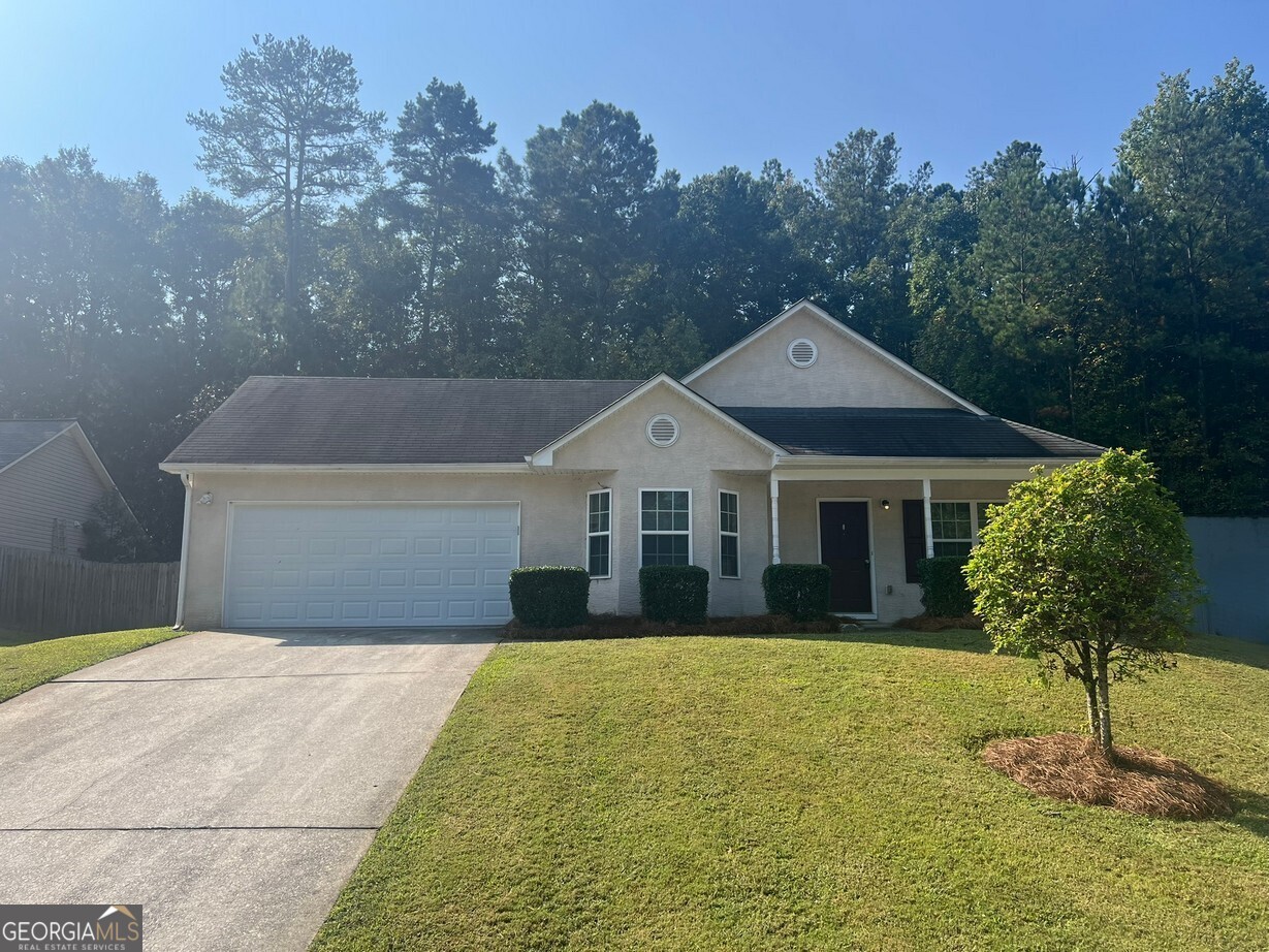 This beautifully updated 3 bedroom, 2 bath ranch is move-in ready with LVP flooring throughout and fresh interior paint. The oversized family room features a high ceiling and a cozy corner fireplace, while the kitchen offers a breakfast bar and adjoining breakfast room. The spacious master suite includes a walk-in closet plus an additional closet, and a private bath with dual vanity, soaking tub, and separate shower. Two generous guest bedrooms share a hall bath. Additional highlights include a laundry room, two-car garage with automatic opener, rocking chair front porch, rear patio, and a huge privacy-fenced backyard-perfect for outdoor living. Conveniently located near I-20, Piedmont Rockdale Hospital, shopping, dining, and all that Conyers has to offer.