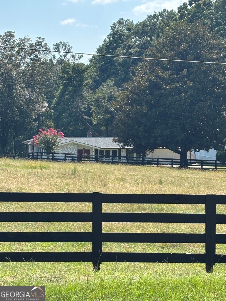Charming Mini Horse Farm on 4.9 Private Acres Welcome to your own slice of country paradise! This gorgeous mini horse farm is tucked away on a peaceful, private 4.9-acre lot, surrounded by nature yet just 10 minutes from downtown Newnan. The beautifully updated 3 bedroom ranch is enclosed by elegant four-board black fencing and offers modern comforts, including a brand-new HVAC system and new roofs on both the home and barn. Enjoy outdoor living with a fully fenced backyard; perfect for your dogs, cats, or other pets to roam and a spacious deck with a charming gazebo, ideal for entertaining family and friends. Equestrians will love the fully functional 4-stall horse barn featuring concrete floors with mats, hot and cold running water, fans, and lighting in each stall. The barn also includes a hayloft, a wash stall, and plenty of space for tractors and storage; all supplied by a deep well for water. Need workspace? You'll find an oversized 23x50 powered workshop a dream come true for any hobbyist or craftsman. And for those with a green thumb, there's a garden ready to grow your own fruits and vegetables, making this property a true homesteader's haven