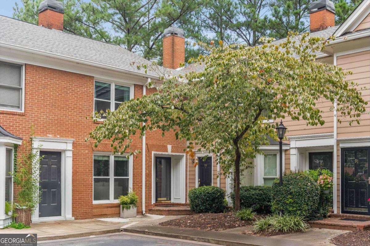 Say hello to this beautifully renovated two-story condo in the esteemed City of Sandy Springs! Tucked away in the coveted gated community of The Accolades, this stylish and low-maintenance gem lives like a townhome without all the upkeep! A timeless brick exterior gives a warm welcome, while the sun-soaked interior showcases a neutral color palette and hardwood floors throughout the main level. Inside, you'll find thoughtful updates, including newer windows (2020), a 3-year-old HVAC, 5-year-old water heater and freshly painted kitchen cabinets that add a modern, yet classic touch. Cozy up in the fireside family room for movie nights or host friends with ease in the generously sized space. A bright, airy dining room is open to the kitchen and flows effortlessly into the charming solarium-style breakfast nook, complete with floor-to-ceiling windows. It's the perfect spot for morning coffee or weekend brunch! Functional as it is attractive, the well-equipped kitchen boasts white cabinetry, granite counters, stainless steel appliances, abundant prep and storage space, and a breakfast bar that comfortably seats two. Unwind on the back deck conveniently located off the breakfast area. A chic powder room highlighted by a shiplap accent wall and updated vanity completes the main level. Retreat upstairs to two sizable bedrooms, each with its own en-suite bathroom, making it ideal for guest privacy or a considerable roommate floor plan. Flaunting three closets (including one with built-in shelving!), the large primary bedroom provides significant storage and a refreshed bathroom with new vanity! Premier location for commuting in or outside the perimeter. Close to GA 400 and I-285. Moments to shopping, dining, Publix, Sandy Springs City Center, Steel Canyon Golf Course, Perimeter Mall, Northside Hospital and Morgan Falls Overlook Park with stunning views overlooking the Chattahoochee River, hiking trails, pavilions, stand up paddle boarding, canoeing and kayaking rentals, playground, dog park and access to the Springway hardscape trail! Community amenities include a pool, tennis courts, clubhouse and pet stations. A beauty that truly has it all!
