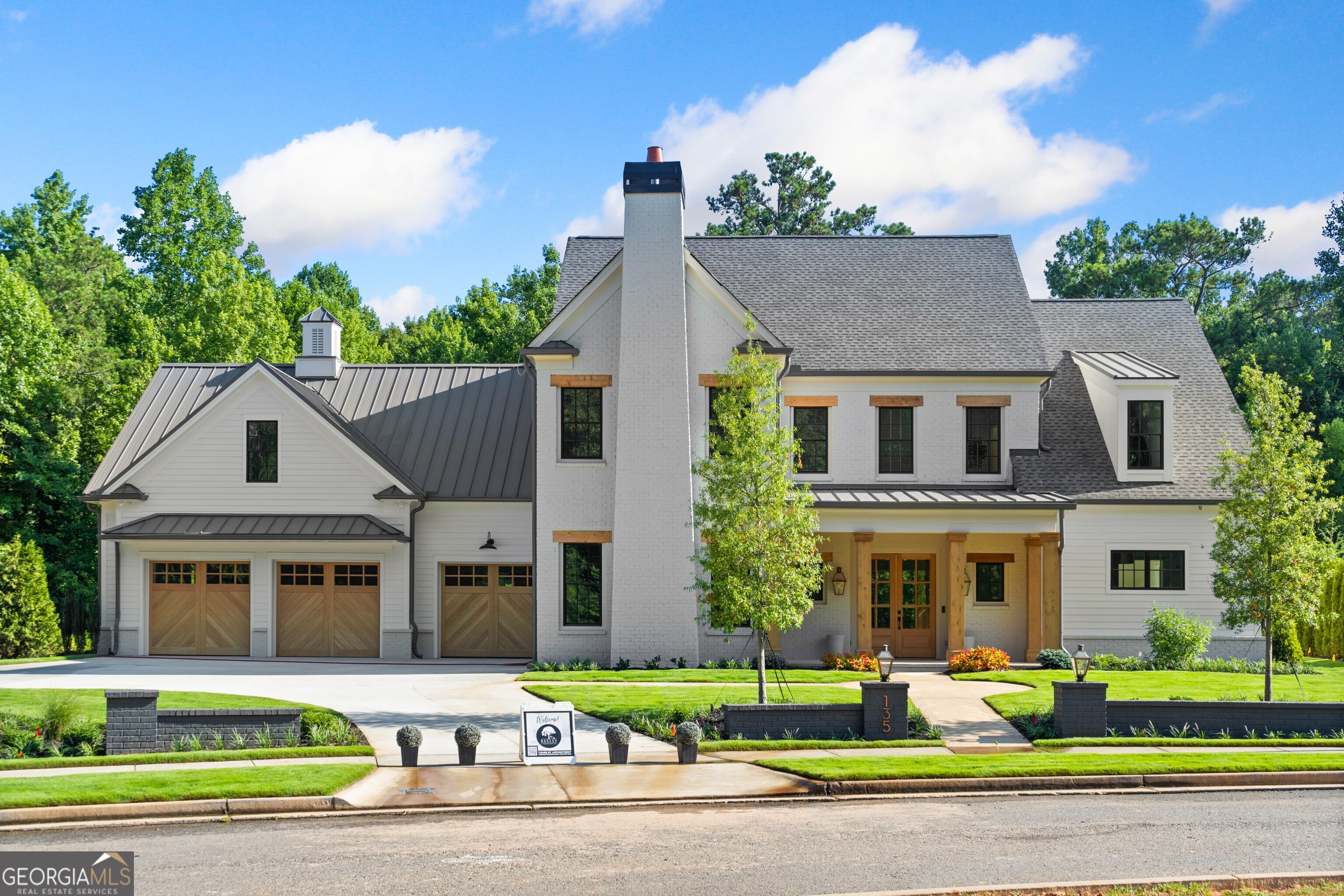 This brand new luxury estate, ideally located within walking distance of downtown Alpharetta's shops and dining, This dream home offers 6 bedrooms and 5 bathrooms, with every detail crafted to perfection. A hand-cut limestone paver walkway leads to the front porch entrance, where you'll find custom stained herringbone white oak entry and hardwood floors throughout. The main level features an inviting entry with a reading nook, a spacious great room with custom cabinetry, a linear fireplace, and frescoed walls. The oversized kitchen is a chef's dream with a massive island, Quartz countertops, WOLF appliances, double ovens, a double-wide range, built-in coffee machine, wine fridge, huge Sub Zero Refrigerator and gorgeous custom stained Inset cabinetry. A walk-in pantry, central home control room, laundry, mudroom, and pet feeding area with bowl filler faucet connect to the 5-car garage, which includes a universal electric car charger and a marble-tiled pet bath area with a retractable ramp. The garage also provides backyard access. A private vaulted and beamed back porch off the Great Room features a built-in fireplace, wine fridge, and grill which can be enclosed as a screened in porch with the remote controlled Phantom Screens. A lovely entertaining and relaxing space overlooking a private, level, wooded fenced yard. A whole-home Generac generator is located on the side yard. Situated on the main floor is the luxurious primary wing which offers abundant natural light and a spa-like bathroom complete with heated flooring, a large shower with heated bench seating, double vanities, and a bespoke closet with built-in safe. There is also a guest suite/office with a custom limestone fireplace and built ins. Upstairs, a light-filled loft area leads to three additional bedrooms with custom closets and en-suite baths, a family living area with cathedral ceilings, and a massive recreational space with multiple closets and a back stairway to the garage. This exceptional home seamlessly blends luxury living with the convenience of a walkable lifestyle, offering the best of both worlds. Custom-built by Chathambuilt with over $150,000 in upgrades, every detail has been carefully curated to provide the ultimate in comfort and style. Additional added benefit is Baxley HOA includes all yard maintenance, so no mowing or clipping, all done through HOA and all completed the same day throughout the neighborhood. It's the perfect combination of sophisticated design, urban convenience all with gated privacy and seclusion, right in the heart of Alpharetta.