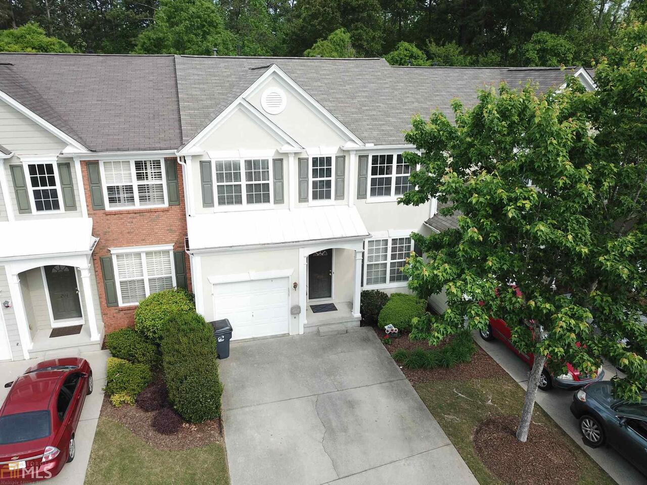 BACK ON MARKET! BASEMENT unit (3 Floors), in-law suite with full bedroom, full bath, office area, storage in basement. One car garage, large common backyard area with private extended deck and patio. New roof 2018. Three bedrooms and two baths up. Two story great room and foyer. Upgrades: Hardwoods, walk-in showers, walk-in closets, granite, tile, lighting and more! Sought after Cambridge school district, walk to eat/shop, minutes to GA 400 and highway 9. Amenities include Olympic pool and playground.
