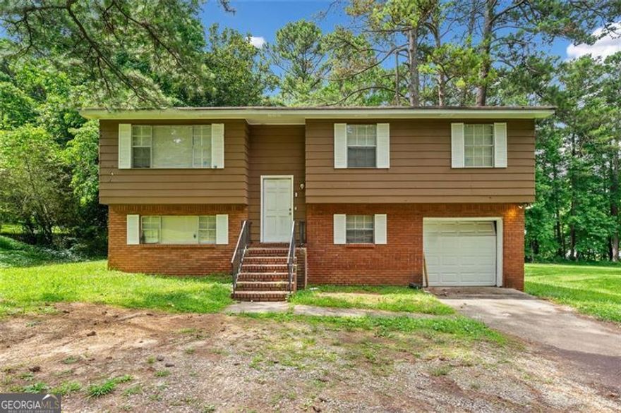 Investment Opportunity on this Riverdale Split Foyer!!  Main level open plan features a living room, dining room, tiled kitchen with separate wall oven and cooktop. Three spacious bedrooms, the full bath has direct access from the Master. Lower level has an additional bedroom, full bath, fireside den with french doors that leads to a covered patio area for additional outdoor living space, separate laundry area with additional storage space. The deck overlooks the large level backyard, a nice size front yard and 1 Car garage. This property is an excellent value for the amount of finished sq. ft. Prime location within walking distance to Community Gardens/Flat Shoals Park, close proximity to schools, shops, restaurants, amphitheater, and more. Only mins. from Hartsfield-Jackson Airport. Convenient to I-85, I-285!  NO HOA, NO SELLER DISCLOSURES, NO BLIND OFFERS.