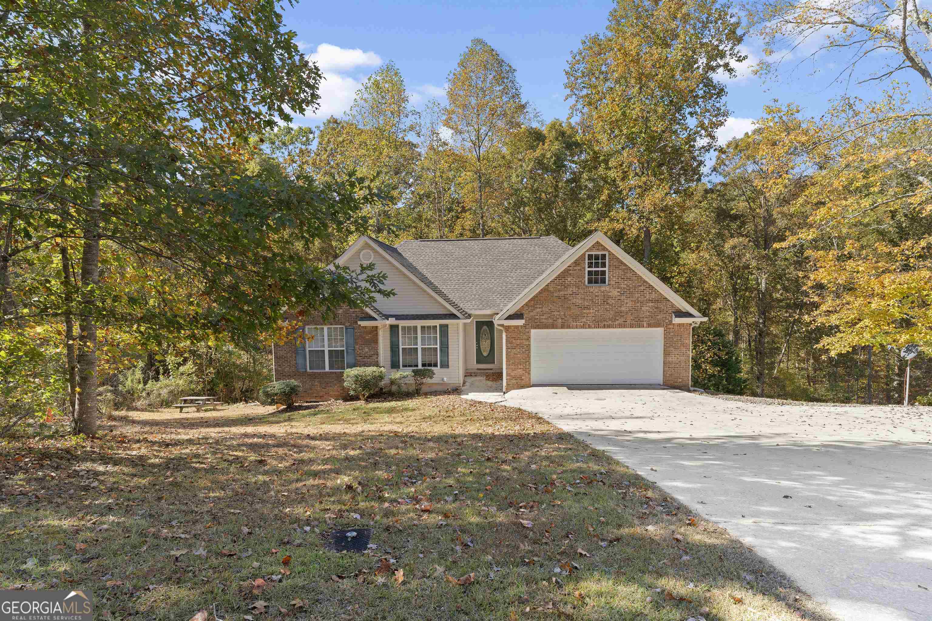 Charming home with a brick front accent, nestle in a quiet neighborhood. Owner's suite and 2 secondary bedrooms on the main level, plus a bonus/flex room upstairs that could make a great home-office, playroom, study or anything you would like. Unfinished basement with a partially finished full bathroom. All kitchen Appliances are included. Laminate countertops and stained cabinets in the kitchen. Berber carpet in the family room with a propane gas starter fireplace. Three bedrooms also have Berber carpet. Tile floors in both upper bathrooms. Spacious master bedroom with a trey ceiling and walk-in closet. Laundry/mud room connecting the garage to the kitchen. Explore the possibilities. Only 20 miles to beautiful Helen, Ga, 30 miles to Dahlonega, GA. With this home you will be surrounded by the breathtaking North Georgia Mountains, life at its best! - contact us for a viewing today! * House is eligible for USDA 100% financing.