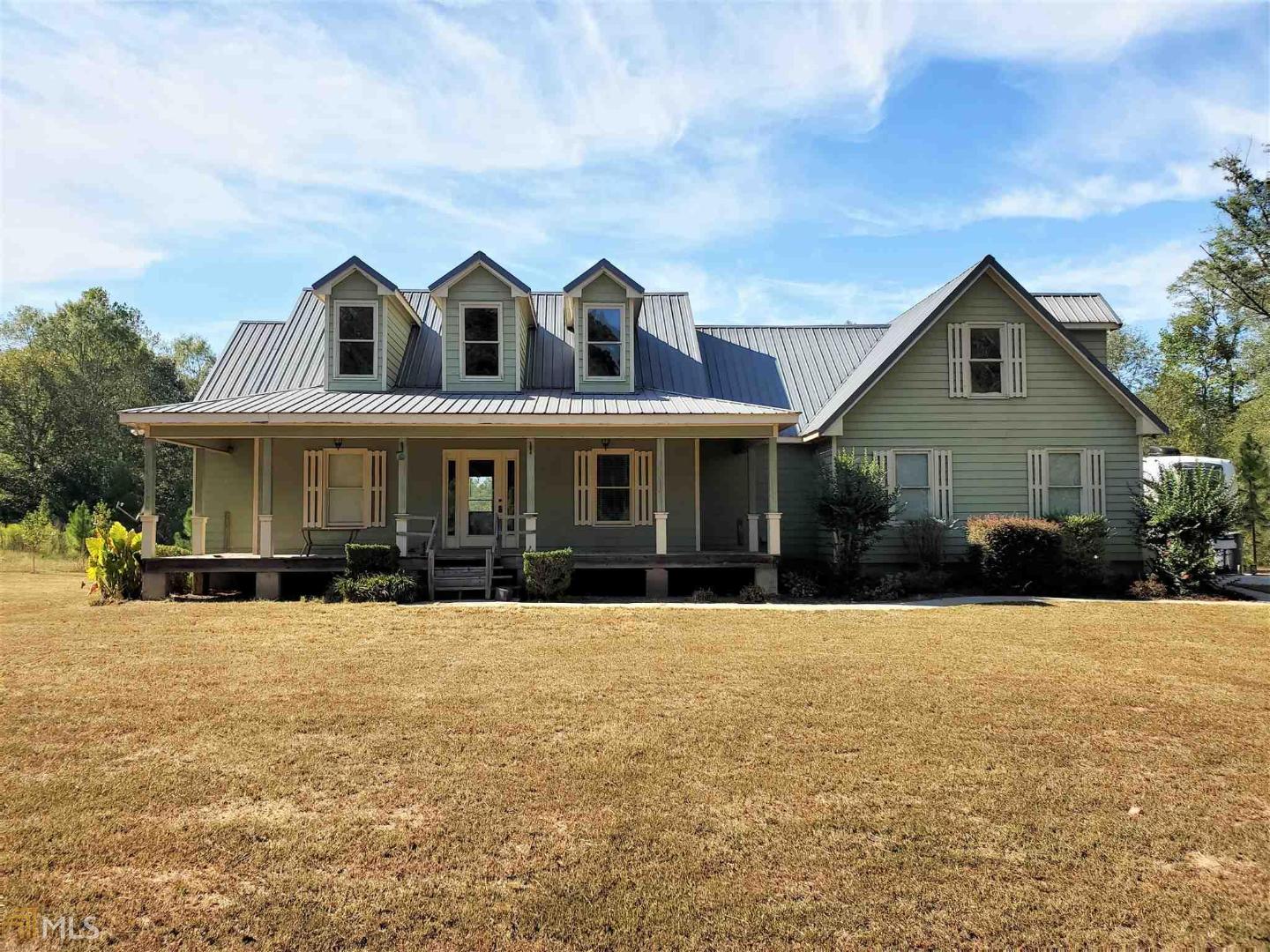 Country living at its finest! Tin roof house on 5 acres of land. Not far from Monticello square. Inside you'll find hardwood floors throughout, high ceilings, tasteful color scheme and modern open layout. Cook friendly kitchen with lots of cabinet and counter space. Separate dining room, and sitting room. Spacious bedrooms and baths. Master suite has trey ceiling, walk in closet, and tile floor bath with large soaking tub and separate shower. Oversized garage has room for two vehicles as well as other storage. Outside features large front porch and back deck. 5 acres has plenty of open land for children and pets to roam and play. House has lots of potential just needs your finishing touches! Call us today for more info.