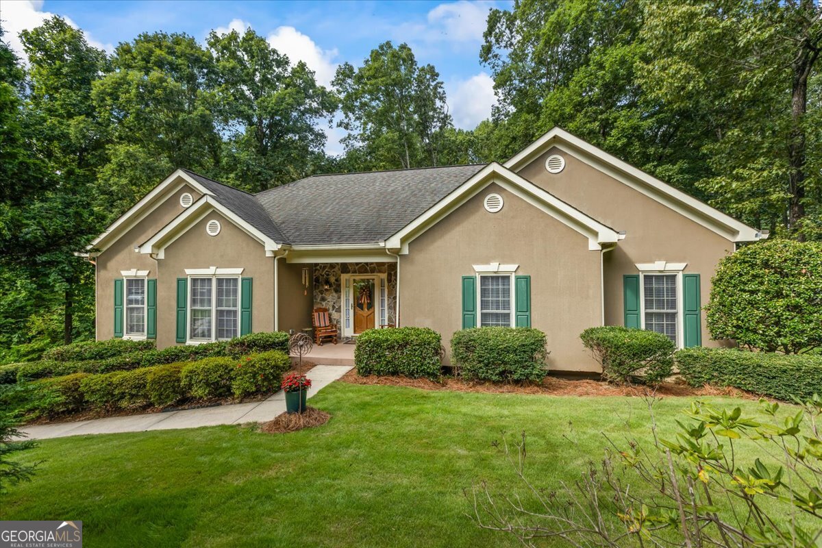 Immaculate 3 bdrm/4 bath home with bonus room. Kitchen features breakfast bar, granite countertops, and stainless steel appliances, Bosch dishwasher(2023). Separate dining room. Great room with gas logs, hardwood floors. Spacious owners suite on the main floor, features his and her walk-in closets, as well as separate shower and tub, marble countertops. Ample laundry room is equipped with electric and gas dryer connection, as well as extra storage units. The basement den is complete with refreshment area. Home features a 3 car garage. Step onto the newly painted deck overlooking a lush Zoysia backyard with creek. The terrace level patio offers a serene escape. This home is a treasure trove of versatile living and abundant storage throughout. Nestled in a swim/tennis community, enjoy the community lake, clubhouse and playground. Plus, the neighborhood boasts a swim team. Enjoy easy access to dining and shopping