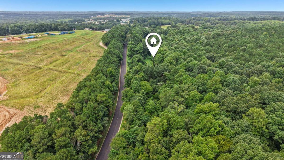 DON'T MISS THIS INCREDIBLE OPPORTUNITY! Versatile 7.75 acre lot with significant road frontage near Bill Rutledge Rd - ideal for residential, multi-family, or potential commercial use. Surrounded by established businesses and just minutes from Fort Yargo State Park, this prime location offers endless possibilities for investors and developers. Contact us today to explore the potential!
