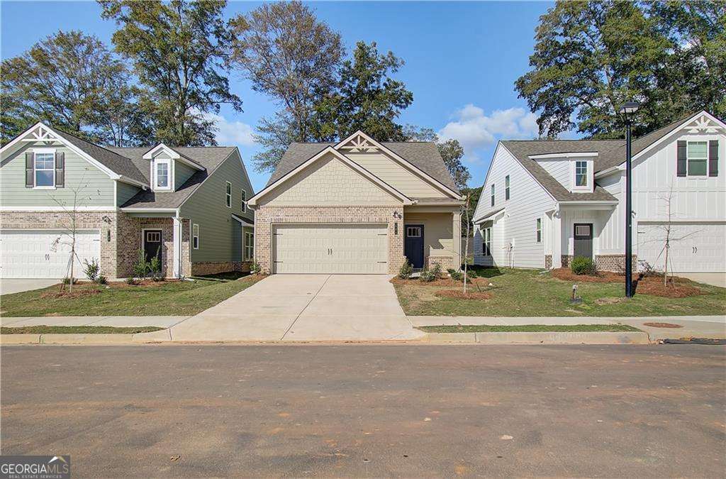 Quick Move In! Ready Now!!! Welcome home to the EMMA at Towne Center on Lot 178, located in the highly sought-after Hampton community by DRB Homes! This exquisite single-family home showcases a stunning Craftsman exterior that enhances its curb appeal and welcomes you in with warmth and style. Spanning a generous layout, the EMMA plan features 3 bedrooms and 2.5 bathrooms, all thoughtfully designed for modern living. The main level boasts an open-concept design, perfect for entertaining and everyday family life. The spacious family room flows effortlessly into the kitchen, creating an inviting atmosphere. The kitchen is truly a highlight of this home, featuring an expansive island with luxurious quartz countertops, providing ample space for meal prep and casual dining. Beautiful cabinetry adds both style and functionality, while the generous walk-in pantry ensures that all your culinary essentials are within easy reach. Conveniently located on the main level, the owner's suite serves as a tranquil retreat. This thoughtfully designed space offers both privacy and comfort, with an en-suite bathroom featuring modern fixtures and ample storage. As you head upstairs, you'll discover a large loft area, perfect for a home office, playroom, or additional living space. Two sizable secondary bedrooms each come with walk-in closets, providing plenty of room for family members or guests. Please note that the photos may not represent the actual home, but they give a glimpse into the quality and design you can expect. Don't miss out on this opportunity to make the EMMA your new home in the vibrant Hampton community! Please note: If the buyer is represented by a broker/agent, DRB REQUIRES the buyer's broker/agent to be present during the initial meeting with DRB's sales personnel to ensure proper representation.