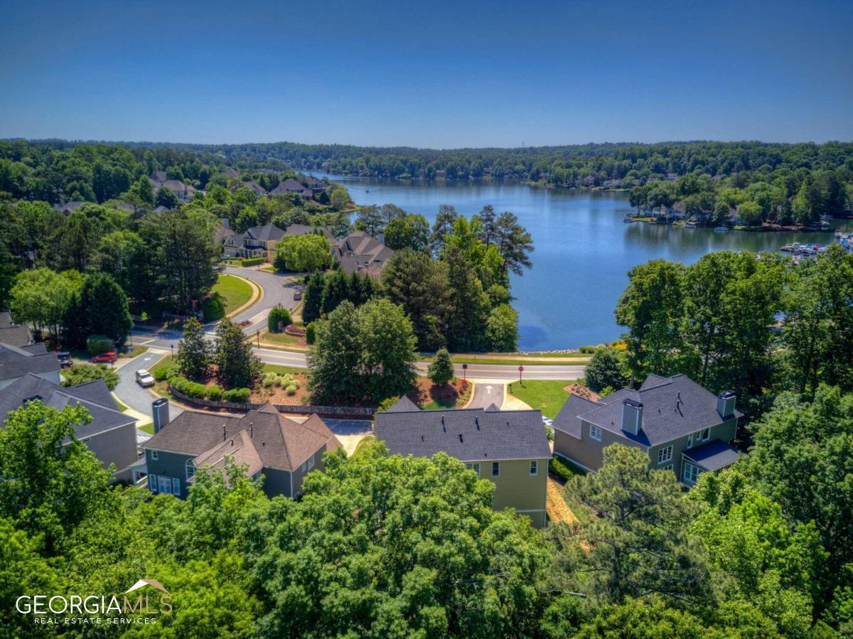 Opportunity is knocking in Windward and now is the time to answer! This beautiful cottage in the Harbour Walk subdivision is sure to impress from the moment you see its beautiful gardens, open floor plan, and sunlit rooms. Walk past the pretty front porchas seating area and inside the foyer to be instantly greeted by the great roomas cathedral ceiling, massive arched windows, hardwood flooring, and gas fireplace. From this room, you can easily access the back deck, which overlooks the beautifully landscaped small, fenced yard. Back inside, you will notice the homeas dining area conveniently situated between the great room and the entertaineras bar in the kitchen. This fully equipped kitchen features high ceilings, stainless appliances, stone counters, a gas range, and a bright seating area, perfect for your morning coffee. Also located on the main level is the impressive owneras suite with wall-to-wall windows overlooking the stone path and gardens, trey ceiling, and French doors leading to a fully renovated spa bathroom, complete with soaking tub, large, designer shower, dual vanities, and modern flooring and fixtures. After dreaming about using that luxurious shower, venture up the pretty hardwood stairs to the perfect flex space. This loft, overlooking the great room, offers the perfect space for an office, playroom, or media room. Also on this level are two sizeable secondary bedrooms and a large hallway bathroom. Other notable home features include an unfinished basement (stubbed for bath) with Trotter waterproofing, a new Precision garage door, Rain Bird sprinkler system, brick and weatherboard cement siding (with siding warranty), and neutral paint throughout. Homeowners in Windward enjoy neighborhood amenities, including Lake Windward, soccer fields, and playgrounds. This prestigious community is also home to the Windward Lake Club and The Golf Club of Georgia. Near GA-400, Avalon, Halcyon, shopping, dining & located in a top-rated North Fulton school district.