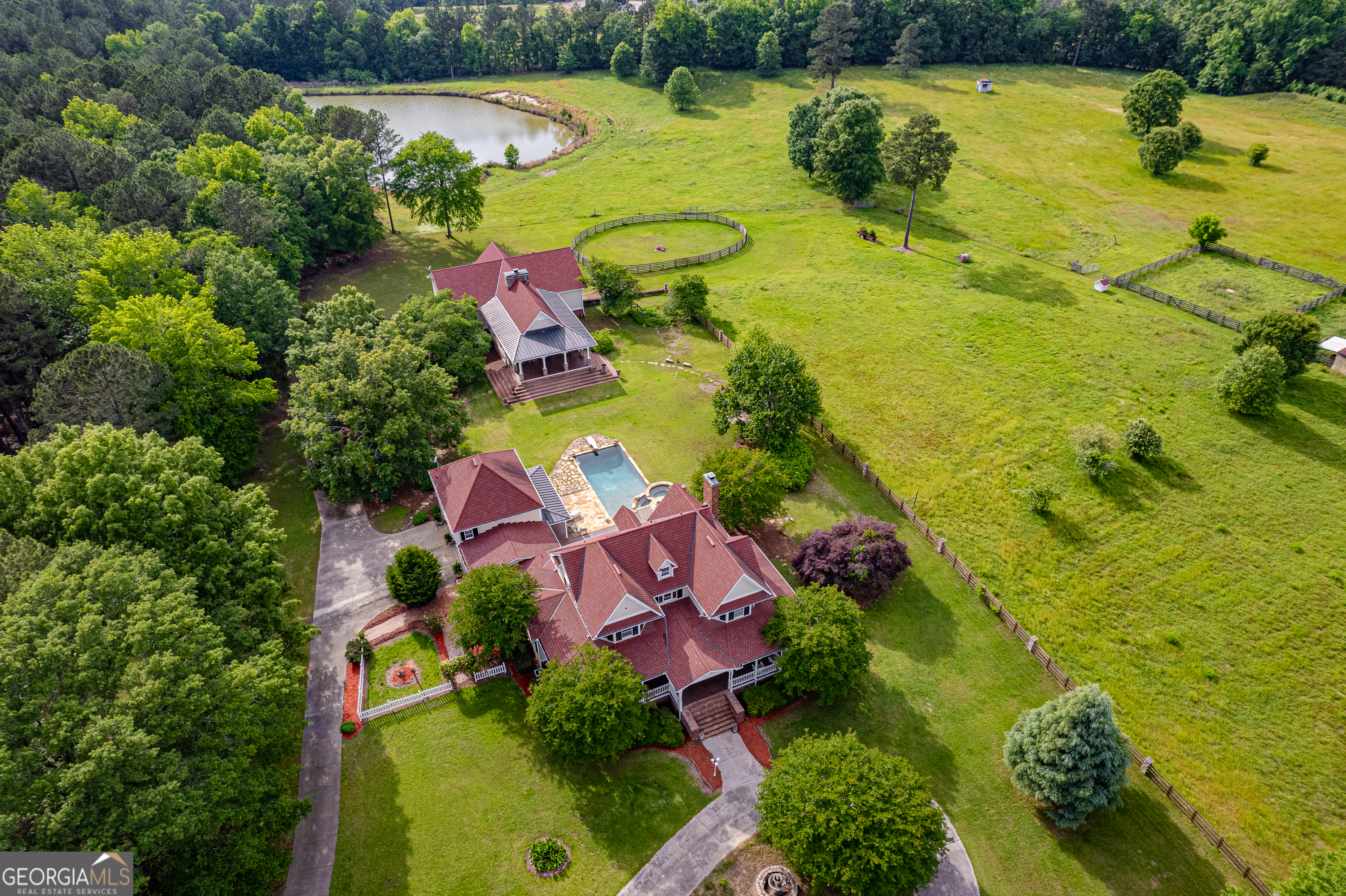Fantastic Country Estate on 86+ ac. Gated & Private with 2 Stocked Ponds + Pasture for Horses or Cattle located in Putnam Co. in between Lake Oconee & Lake Sinclair. The 2-Story Custom Home is Blessed with Deep Covered Porches, 4 Bd, 3 Ba, 4572 sqft, Wood Flooring, Professional Grade Appliances, Granite Tops, Fireplace, In-Law or Teen Suite above the 2 Car Garage, 2nd Kitchen, Sony Theater Room & Living Area, Screen Porch leading out to a Pool, Hot Tub, Double Sided Fireplace & Out Door Kitchen/Grilling Area. The Stable House has 3480 sqft. overlooks the Pool Area, Pond & Pasture. It is the Perfect Place for Entertaining with Rocking Chair Front Porch, Huge Great Room, Stack Stone Fireplace, 20ft Bar, Kitchenette, Guest Suite with Full Bath & 2 Additional Bedrooms. Downstairs you will find a 300sqft Wine Cellar, Dance/Gym Space, Storage, and the Barn Area offering 2 Oversized Stalls, Tack & Feed Rooms, 1/2 Bath, Workshop & Laundry Room. Pasture is Fenced & Cross Fenced with Round Pen, Run In Shelter & Paddocks. Approx. 40 ac. of Mature GA Pines. Home Warranty Included with Sale
