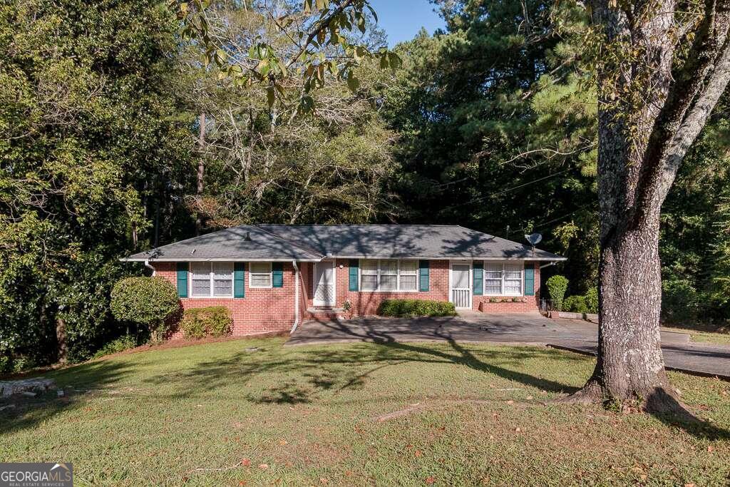 Welcome to 181 Westview Street!  This all-brick ranch home is situated on a picturesque lot in the quaint neighborhood of Cherokee Heights, just one mile from downtown Canton and The Mill on Etowah.  Featuring two beds and one bath, this charming home has the original hardwood floors and vintage mint green tile in the bath.  The main living area offers a seamless flow to the dining area and kitchen.  There is a sunny den also adjacent to the kitchen and a separate laundry room with a door leading out to the back deck.  The back yard is completely fenced, and the surrounding trees provide privacy and shade--a perfect setting for relaxing on the deck.  There is ample storage in the partial basement, which you can enter from the back yard.  This home is equipped with storm windows, and the HVAC was replaced in 2022 and water heater was replaced in 2020.   Unbeatable convenience to everything Canton has to offerCoshopping, dining, entertainment, Etowah River Park, schools, and just over one mile to I-575.  Preferred closing attorney is Hartman Law, Woodstock.  Sold as-is with right to inspect.