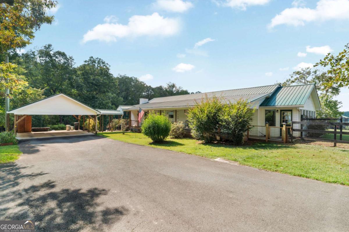 For equestrians who've been waiting on the one-this 10-acre farm in Jasper is a true move-in-ready horse property wrapped in old-homesite charm. Set on a corner lot with frontage on Bryant Road and Watson Lake, the land itself is the heart of the story: ~6.5 acres of cross-fenced pasture already prepped for livestock, shaded by century-old oaks and catalpa trees, with a seasonal stream at the back and private access to an 18-acre shared lake stocked with bass, crappie, and catfish. The fully restored 1942 farmhouse blends history with modern comfort. Original hardwood floors were brought back to life, complemented by new LVP flooring in the living spaces. The remodeled kitchen features custom cabinetry, dual pantries, hidden lazy Susans, and newer appliances. With three bedrooms, two baths, and a versatile bonus room that can flex as an office, gym, or fourth bedroom, there's space for both family and farm life. Outside, a large covered porch, two sunrooms, and a firepit create gathering places for every season. Horse amenities shine here: a six-stall barn fully rehabbed inside and out, with custom pine-and-iron fronts, matted stalls, exterior Dutch doors, tack room, water, upgraded 200-amp power, fans, cross ties, and loft space for hay or storage. Double sliding doors allow easy airflow and security, while the ~50' round pen sits just outside. The property also includes a two-story storage shed with lean-to, a double carport, three yard hydrants, and secure fencing (no direct pasture access from public roads). Every thoughtful improvement has already been made-tree clearing, overseeded pastures, new fencing and gates, new AC and water heater, brand new septic, metal ductwork, and foam insulation-so you can simply step into the lifestyle. Bonfires in the backyard, dogs running free, horses grazing in rolling fields, sunsets over the water-this is where farm life meets everyday comfort, without the "project" list. **Contact the listing agent for this property's website. Here you will have access to VIDEO TOURS of the property, an extensive features and upgrades list, as well as property disclosures.