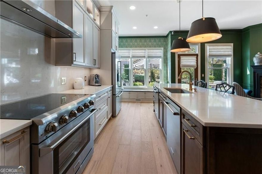 MAJOR PRICE ADJUSTMENT! Do not miss this opportunity to own a stunning, fully renovated townhome in the heart of Downtown Alpharetta for under $1M! Step inside to discover a beautifully updated interior featuring new wide-plank European white oak hardwood floors throughout the house, setting the tone for modern elegance and warmth. At the heart of the home is a gorgeously remodeled kitchen designed for both style and function. Enjoy custom floor-to-ceiling cabinetry with integrated and under-cabinet lighting, an expanded island with hidden trash/recycling, and a custom pantry with pull-out shelving. Pull-out spice and utensil drawers flank the 36" professional gas range and hood. The kitchen also features Quartz counters and backsplash, an air-switch garbage disposal, USB-equipped outlets, and all-new appliances including two dishwashers, a double oven/microwave combo, and a counter-depth refrigerator. The home has been thoughtfully upgraded with 2024 Pella energy-efficient windows and doors, all with hidden screens for a seamless look and maximum efficiency. Hunter Douglas Powerview Roman shades have been installed on the main, offering both luxury and automated convenience. A custom Signet ProVia front door provides enhanced security and insulation. Comfort and peace of mind are further ensured with Lennox HVAC systems (2021 & 2024), a Rheem gas water heater (2018), new ADT-monitored smoke detectors with 10-year batteries, carbon monoxide detectors, and a full ADT-monitored security system. The blinds, thermostats, garage door, security cameras and some light fixtures are smart-enabled for efficiencies, safety and convenience. Additional upscale details include designer light fixtures, Rejuvenation custom switch plates, premium stair runners and fresh interior paint. The three ensuite bedrooms enjoy well-appointed bathrooms, each updated with Kohler toilets and modern fixtures. Academy Park is the only townhome community in Downtown Alpharetta offering resort-style amenities, including a gated entrance, swimming pool, tennis and pickleball courts, a fitness center, clubhouse, wooded walking trails, and direct access to the Alpha Loop and Greenway trail systems. You'll love the walkability, this home is just steps from Avalon and Alpharetta City Center, and only minutes to GA 400, Halcyon and Crabapple Market. Don't miss this rare opportunity to own a move-in-ready, luxury townhome in the best location Alpharetta has to offer. Schedule your private tour of 2630 Milford Lane today!