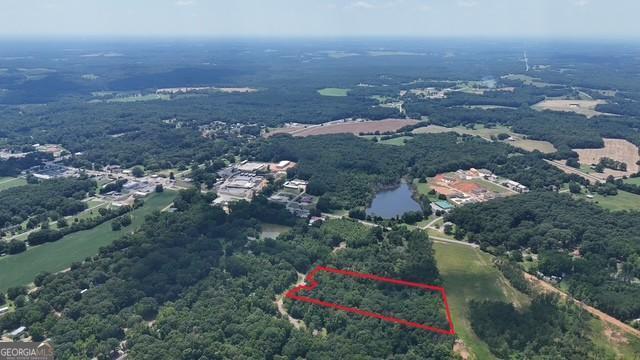 6.38 Acres located at 255 Hillwood dr, Danielsville, Ga . This Property is located less than a mile from Danielsville and 25 minutes north of Athens. The Property host level to rolling topo with a partially cleared homesite towards the frontage of the property and has a Creek flowing through amongst huge hardwoods towards the back of the Property. Mobile Homes Allowed.