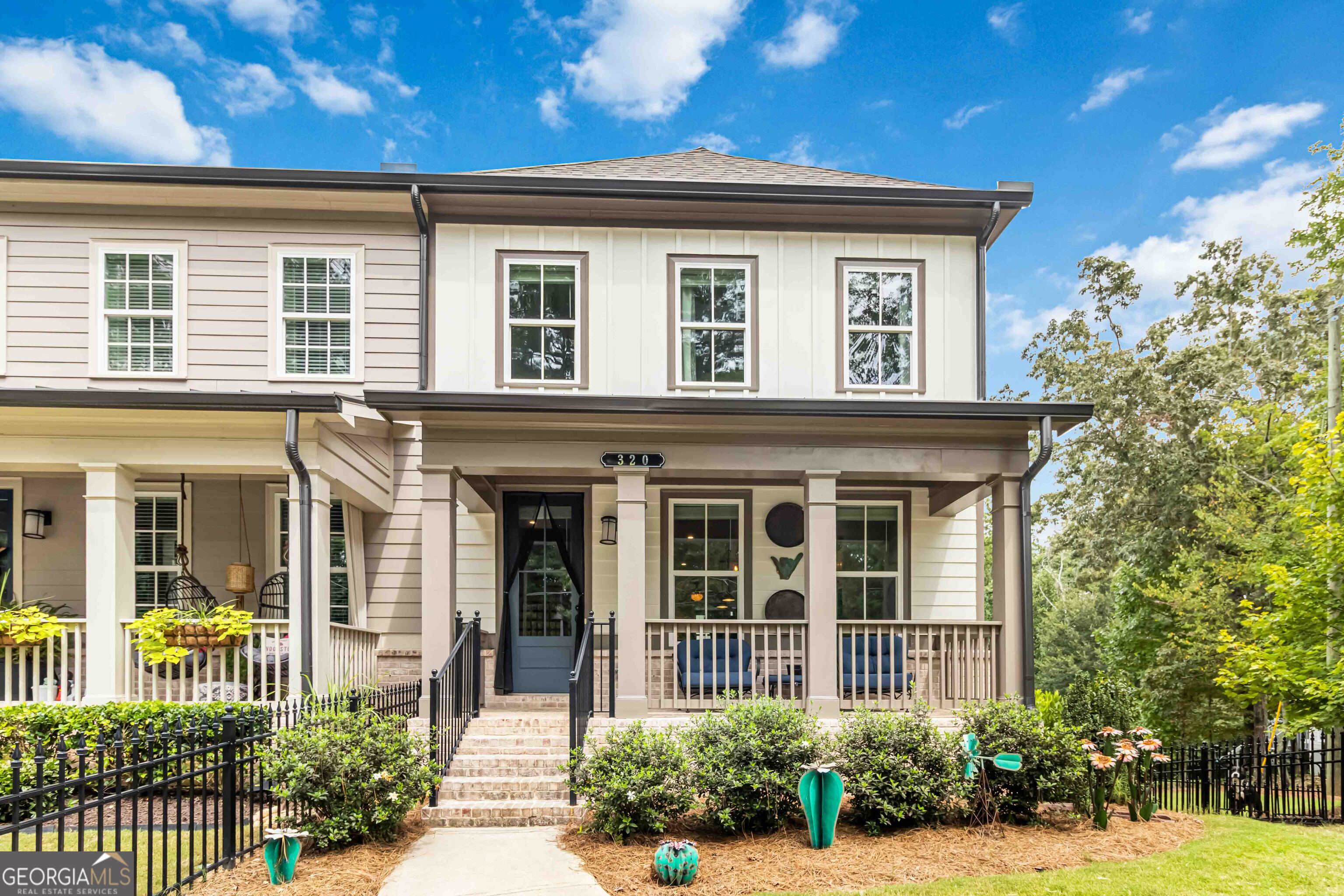 320 Oak Arms Way - Your Woodstock HQ. Unique downtown Woodstock offering of professional Builder's personal Inwood residence. This bright custom end-unit townhome offers 3 bedrooms and 3.5 bathrooms and was handpicked due to is its prime and private setting. From the front and rear dual covered (available on end units only) porches to the private fenced front and side yard, the homes elements are designed to keep your outside living oasis contained and peaceful. Inside, the main floor great room features a gourmet kitchen with 12' quartz island, gas fireplace, separate gas cooktop, and fully integrated light and hardware package, all with enough room to allow for a 10' dining table (as shown) for large gatherings. The terrace level includes a wet bar, mini-refrigerator, and FULL bath with tiled shower. This versatile space is your flex zone-game nights, workouts, or guest crash pad - and it comes complete with direct access to the garage and fenced side yard. Upstairs, the primary suite has a spa-inspired custom shower that you must see to believe. It features a natural stone mosaic flooring, wood effect wall tile, infrared heat light, a built-in seat and multiple shower heads. The bedrooms benefit from the spectacular end location as there are panoramic views from the many windows. From your door, you're a golf cart ride from Downtown Woodstock's buzzing restaurants, breweries, and live music-or minutes to trails, the Outlet Shoppes, and I-575 for quick getaways. Add in Inwood's pool, dog park, fire pit, and community spaces, and you've got more than a home-you've got a lifestyle upgrade. 320 Oak Arms Way isn't just a townhouse-it's your ticket to live bold in Woodstock.