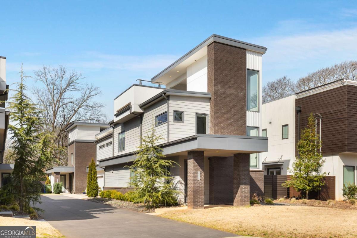 Experience the ultimate Beltline lifestyle in the heart of popular Reynoldstown, this boutique enclave of four city homes were designed for seamless indoor and outdoor living. Only attached at the rear garage, 205-A Wilbur lives like a single family home with four bedrooms, an open floor plan, multiple living and dining areas, amazing natural light, sleek finishes and hardwood floors throughout. The spacious kitchen features stainless steel appliances, a large waterfall island and separate dining area, open to the fireside living room, making it perfect for entertaining. The spacious primary suite features a walk-in closet and sleek bathroom with double vanities, separate toilet and tiled/glass shower. Three additional bedrooms and a full bath, a separate laundry room and extra storage space complete the second level, allowing plenty of room for family, guests or home office needs! Last but not least, the outdoor living and entertaining spaces make this home even more unique! At the top, enjoy a covered roof terrace with a fireplace, plus a sunny area for your green thumb, a private oasis for relaxation or hosting under the stars! The living level opens to a private, fenced side yard and patio for grilling and entertaining! Additional owner upgrades include custom blinds and energy-efficient solar panels! A two car, attached garage next to the kitchen adds further convenience to this Beltline gem, but who needs a car? Step outside and immerse yourself in one of the most vibrant neighborhoods in Atlanta! Walk to top-rated dining, coffee shops, retail, neighborhood parks, the grocery store, even a movie theater! Surrounded by Madison Yards, Atlanta Dairies and other beloved intown Atlanta neighborhoods, including Cabbagetown, Glenwood Park, Ormewood Park, Grant Park, East Atlanta Village, Inman Park and more, this is more than a home, it's a lifestyle!