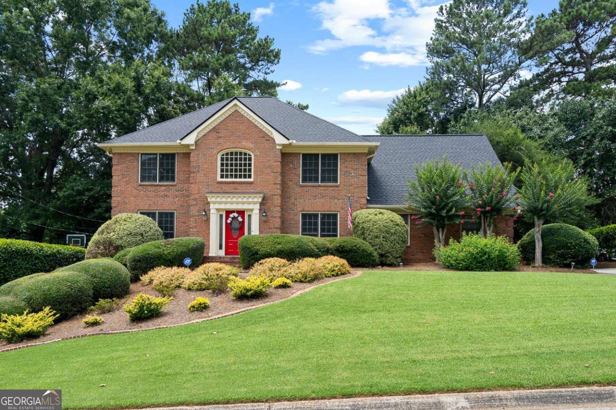 Welcome to 160 Amsterdam Drive, a beautifully maintained 5-bedroom, 3-bath, four-sided brick home located in the highly desirable Woods of Parkview neighborhood. Tucked near the back of the neighborhood and well away from the train, this home delivers curb appeal, a peaceful setting, and a long list of thoughtful updates. Inside, you'll find refinished hardwood floors, brand new carpet, and fresh paint throughout the entire interior (yes, even the ceilings)! The main level features a cozy den with built-in bookcases and a striking 30-foot indoor brick masonry fireplace, while the kitchen is equipped with newer stainless steel appliances and ample cabinet storage. Just off the kitchen, a massive deck with a gazebo overlooks a flat, fenced-in yard that's ideal for outdoor living, gardening, or play. On the main floor is a full bathroom and a bedroom, perfect for guests or to use as a home office. Upstairs, you'll find four spacious bedrooms including the oversized primary suite with a tray ceiling, large walk-in closet, double vanity, separate shower, and whirlpool tub. Additional features include a brand new roof, freshly painted exterior, two HVAC systems, termite warranty with service and repair, wired ADT security, and an irrigation system. The home also includes a full unfinished basement, perfect for storage or a workshop. Residents enjoy access to the neighborhood swim and tennis club and benefit from being in the sought-after Parkview High School cluster. This is a well-cared-for, move-in ready home with standout features both inside and out.