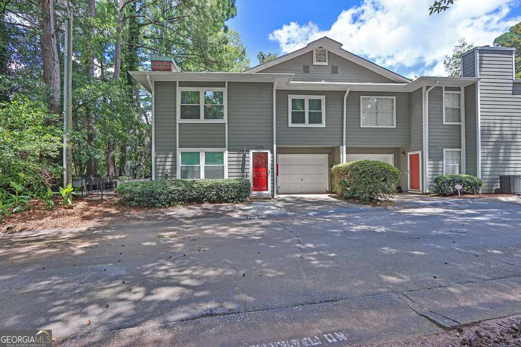 Welcome home! This beautifully updated end-unit townhome is arguably one of the nicest homes in the community. Step inside and fall in love with the open great room complete with fireplace. The fully renovated kitchen features newly painted cabinetry, quartz countertops, stainless-steel appliances and modern fixtures creating the perfect space for cooking and entertaining. Rounding out the first level is the half bath, laundry room, and one-car garage. The transformation continues upstairs to an open loft area w/laminate flooring, creating a separate space perfect for work or play. The primary suite is spacious and leads to a spa-like bath featuring a newer vanity with backsplash, tiled shower, and generous closet w/custom shelving. The secondary roommate style bedroom is also spacious and features a fully renovated ensuite bath with custom shower. The private outdoor patio is ideal for gathering/gardening and is framed by mature greenery that ensures both serenity and privacy. Located in a vibrant, friendly community just minutes from downtown Norcross and convenient access to I-85 and Lawrenceville Highway. Happy Showing!