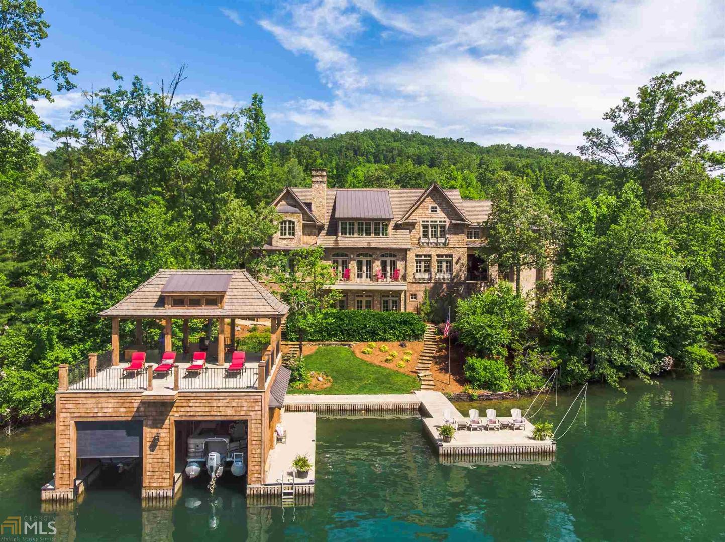 Endless details were thoughtfully included in this true labor of love on Lake Burton. A warm and welcoming ambiance is created through special accents like reclaimed oak flooring and beams, custom venetian plaster, exposed brick and custom hand-distressed cabinetry. With four bedrooms, a rec room with built in bunk beds, and a craft/bonus room, this custom home is perfect for entertaining! Amenities include a spacious custom chef’s kitchen, lakeside four season porch with remote control screens, home gym with sauna and steam shower, three-car garage, terrace level workshop with 2 additional garages, celebrity style walk-in closets, potting solarium, 2 offices and a 2-story boathouse with spectacular lake and mountain views down Timpson Cove.