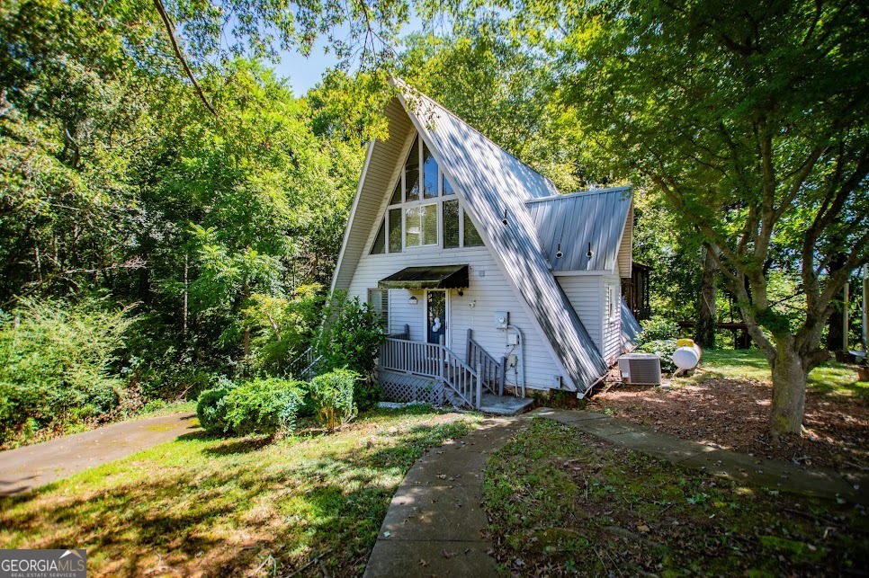 Riverfront Retreat with Loft & Finished Basement- Proven Airbnb/ VRBO Income. This beautiful A-Frame home combines rustic charm and modern comfort -and it's already generating investment income as an active Airbnb/ VRBO! Enjoy the outdoors with a huge screened porch overlooking the river, a relaxing hot tub, and a cozy fire pit. Inside, you will find a family room with vaulted, beamed ceilings, a modern kitchen with stainless steel appliances, plus a loft and finished basement for plenty of extra space. Whether you're looking for a serene personal getaway or a turnkey income property, this home delivers both lifestyle and return on investment.