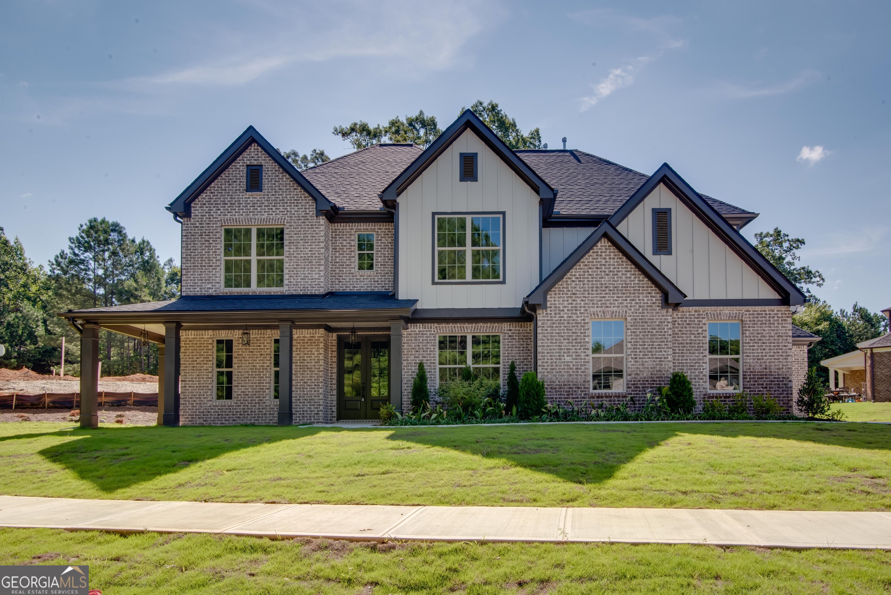 A beautiful new construction located in the community of Le Jardin. This large home features a large open floor plan, living room and dining room with coffered ceilings, family room with fireplace and additional keeping room off kitchen. Beautiful kitchen with 42 inch cabinets with plenty of storage, gas cooktop, wall oven/microwave, separate pantry, large island and separate breakfast area. Five inch real oak hardwood throughout main level. Bedroom and full bath on main level. Upstairs, owners bedroom with sitting lounge and two closets, one with direct access to the laundry room. Spa like owners bath with soaking tub and spa style shower. Large secondary bedrooms with shared jack n jill bath and fifth bedroom with a private bath. Incredible wrap around front porch. Large back covered patio overlooking the lovely backyard. Three car garage.