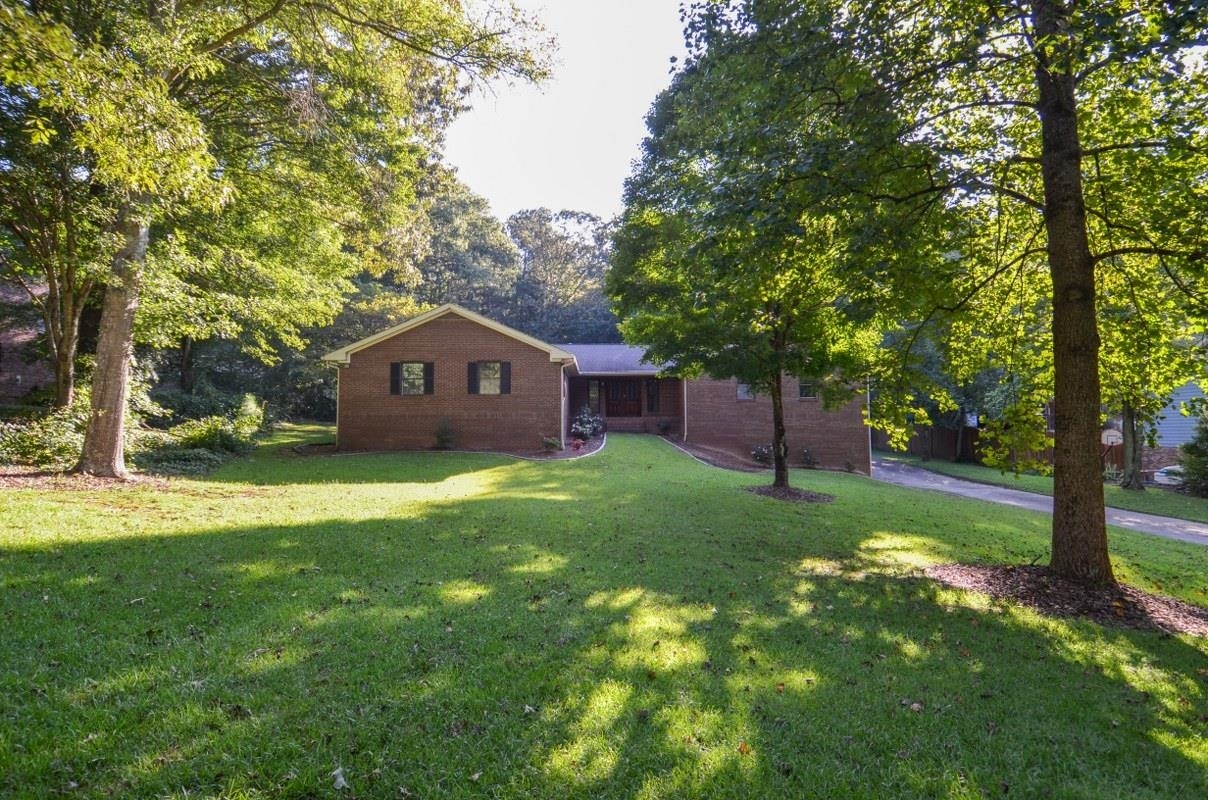 Custom-built ranch home sits on a 1.95-acre lot tucked away in a small and quaint subdivision with NO HOA. Premier location near shopping, dining and entertainment with easy access to 85. This incredible floor plan has everything you need including an oversized family room that can handle a large crowd as you entertain. The kitchen features oversized island, tons cabinetry, double ovens, cooktop, plenty of counterspace, breakfast area and a banquet size dining. All these rooms are very generous in size. This home features 4 bedrooms 3.5 bath on a full unfinished basement. Wait to you see the size of the basement, so much potential for future space or can be used for storage or a workshop area. The home also provides a 4-car garage, plus another garage in the basement area. This is truly a unique property!