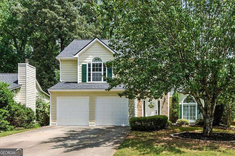 Here's your chance to get into Lake Park, a quiet and established community known for its charm, amenities, and unbeatable location. From the moment you step into the grand two story foyer, this home feels light, open, and welcoming. Fresh paint and brand new carpet throughout make it move in ready from day one. The living room is filled with natural light pouring through oversized windows, highlighting the spacious layout, and plantation shutters throughout keep the cooling bills at bay. A cozy fireplace adds the perfect touch for relaxed evenings or weekend entertaining. The living and dining areas flow seamlessly into the kitchen, which is both stylish and functional with granite countertops, crisp white cabinetry, a walk in pantry, and a sunny breakfast nook that overlooks the backyard. Tucked away on the main level, the primary suite offers a true retreat with vaulted ceilings and a spacious ensuite featuring a soaking tub, double vanity, and separate shower. The laundry closet is conveniently located nearby. Upstairs, two oversized guest bedrooms are connected by a Jack and Jill bath, offering comfort, flexibility, and brand new carpet underfoot. Outside, the fenced backyard is made for entertaining or everyday unwinding, complete with a refinished deck, expansive patio, and built-in fire pit. The newer roof and freshly painted two car garage adds even more value, while neighborhood amenities like two pools, tennis courts, basketball courts, playgrounds, and sand volleyball court seal the deal. With quick access to shopping, dining, and major commuter routes, this home delivers the lifestyle you've been looking for in one of the area's most welcoming neighborhoods.