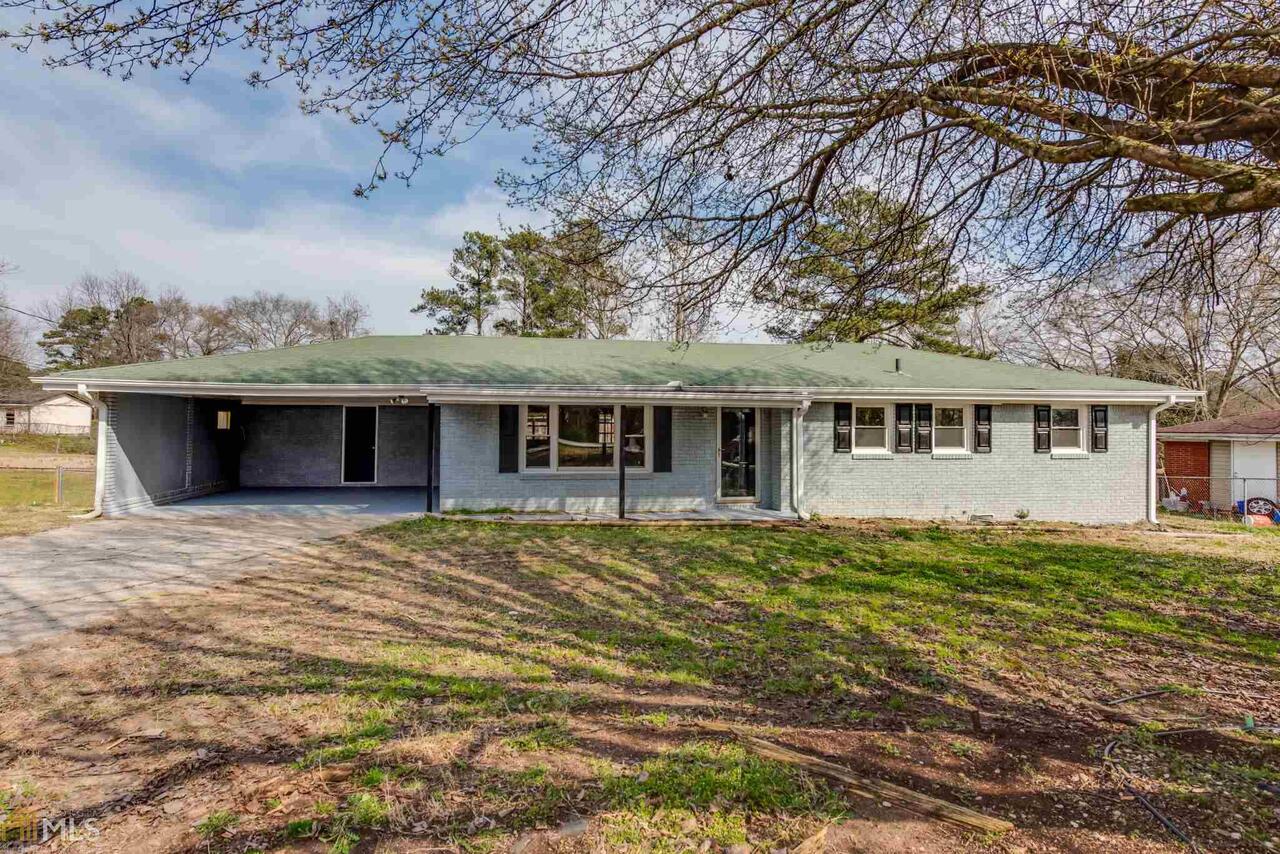 BACK ON MARKET DUE TO NO FAULT OF THE SELLER! New flooring, paint and oven! This four sided brick ranch is perfect if you are looking for stepless living in a convenient location. Home is convenient to everything Douglasville has to offer and I-20! The backyard is very large and makes a perfect place for fur babies to play, you will also find two outbuildings so no need to worry about storage! The back deck is covered and perfect for entertaining! You can fit the whole family on it for cookouts! Schedule your appointment today before it's too late. Home is being sold "AS IS."