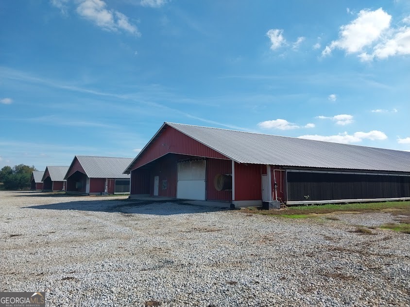 If you're looking for a large broiler farm that is well maintained with all the "bells and whistles", look no further. This choice farm features 364,800 square feet of bird area situated on a vast 170 +/- acre parcel that includes a total of 14 broiler houses, all of which have new 56 stage Choretronics 3 controllers, digital scale bins, tube heaters, tunnel doors, and any upgrade/premium you can imagine.  Farm has natural gas and public water availability, but who needs public water when you have 6 wells that produce 1,000+ gallons per minute! You will have to look at alot of farms to find one that is close to being as well maintained and as well laid out as this farm.  In addition to the primary poultry area, the farm features a custom 3,600 +/- square feet brick residence, a heated/cooled shop that any mechanic would dream to have, 3 stack houses, multiple other barns, lush hay fields, planted pines, private pond, room to expand, no close neighbors, and much more. This farm meets or exceeds integrators premium contract with no required upgrades and has exceeded integrator projections over the past 2+ years while maintaining low operating costs due to houses being fully solid wall with upgraded insulation, energy efficient heaters/fans, doors, etc.  Seller will provide a new survey with all boundaries marked.  While the seller desires to sell the farm, the farm can not be showed without 24 hours notice, buyers   pre-approval for financing and all visitors must meet biosecurity measures at the time of showing. 2 year financials are available and this farm will cash flow and then some! NO DRIVE-BY'S; listing agent must be present at the time of showing.   Please call listing agent today @ 706-491-7272 to arrange a private showing.