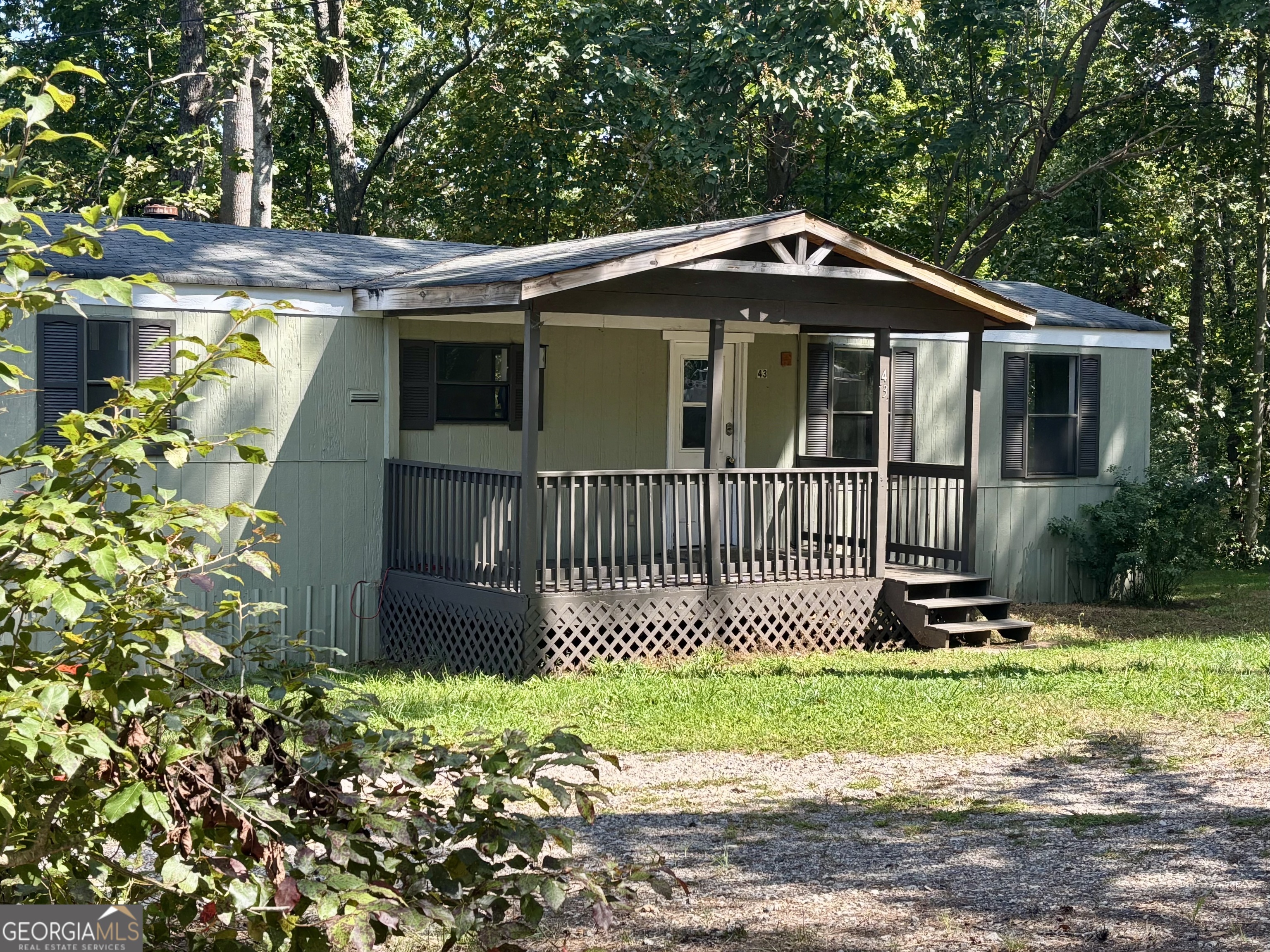 2/1 mobile home sits on a permanent foundation with retired titles, making it financeable and a fantastic long-term investment. Corner, private 1.31-acre lot, the property offers both seclusion and convenience, located just off Hwy 9 for easy access to shopping, dining, and commuting route. This well-maintained home features updates that appeal to today's buyer and/or renters. A major bonus is the on-site storage building, ideal for tools, lawn gear, etc. With no HOA restrictions, you'll have the freedom you want with the property, so much potential with this one!