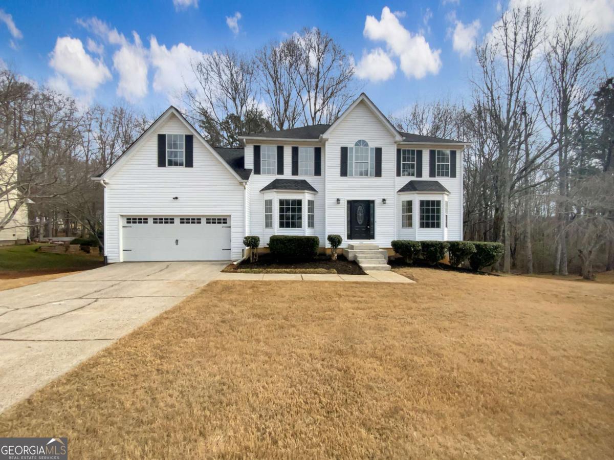 Welcome to this beautiful 4-bedroom, 2.5-bath home in the desirable Greenfield subdivision of Cumming! With fantastic curb appeal, a level driveway, and charming landscaping, this home is sure to impress. The white exterior with modern black trim gives it a stylish touch, while inside, the freshly painted interior and LVP flooring on the main level make it completely move-in ready. The updated kitchen flows seamlessly into the living and dining areas, with access to a spacious deck-perfect for entertaining. The large master suite features a bathroom with dual sinks, a soaking tub, and a separate shower. The full basement offers tons of flexibility, including a partially finished 5th bedroom that just needs flooring-ideal for a home office, gym, or guest space. The backyard gently slopes to a peaceful creek, providing a serene outdoor retreat. Don't miss this incredible opportunity!