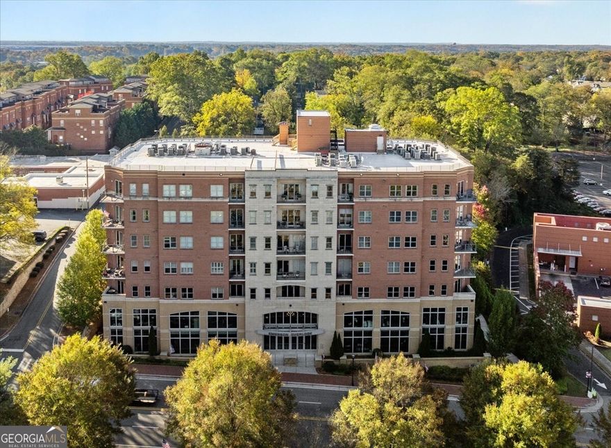 Welcome to Emerson Overlook and the Marietta Square! Create the low stress lifestyle you have been longing to have, and all located in a highly desirable location! This amazing 2-bedroom, 2-full bathroom plus den/bonus room gem is waiting for you to make this home yours. The space is generous for you and your loved ones. As you step inside, you'll be greeted by the warm and inviting atmosphere of this residence. The open floor plan seamlessly connects the living spaces, making it perfect for entertaining friends and family. The view is spectacular from this large, corner unit! The kitchen features sleek countertops, stainless appliances and ample storage space. Cooking and dining here will be a delight. This unit has an additional storage unit and two covered, assigned parking spaces located oh so convenient to the entrance for you! Located in the desirable area of Marietta, this home offers easy access to schools, shopping, dining, and parks. It's also a commuter's dream with quick access to major highways. This property is a rare find, and it won't last long on the market. Don't miss your chance to make it yours!