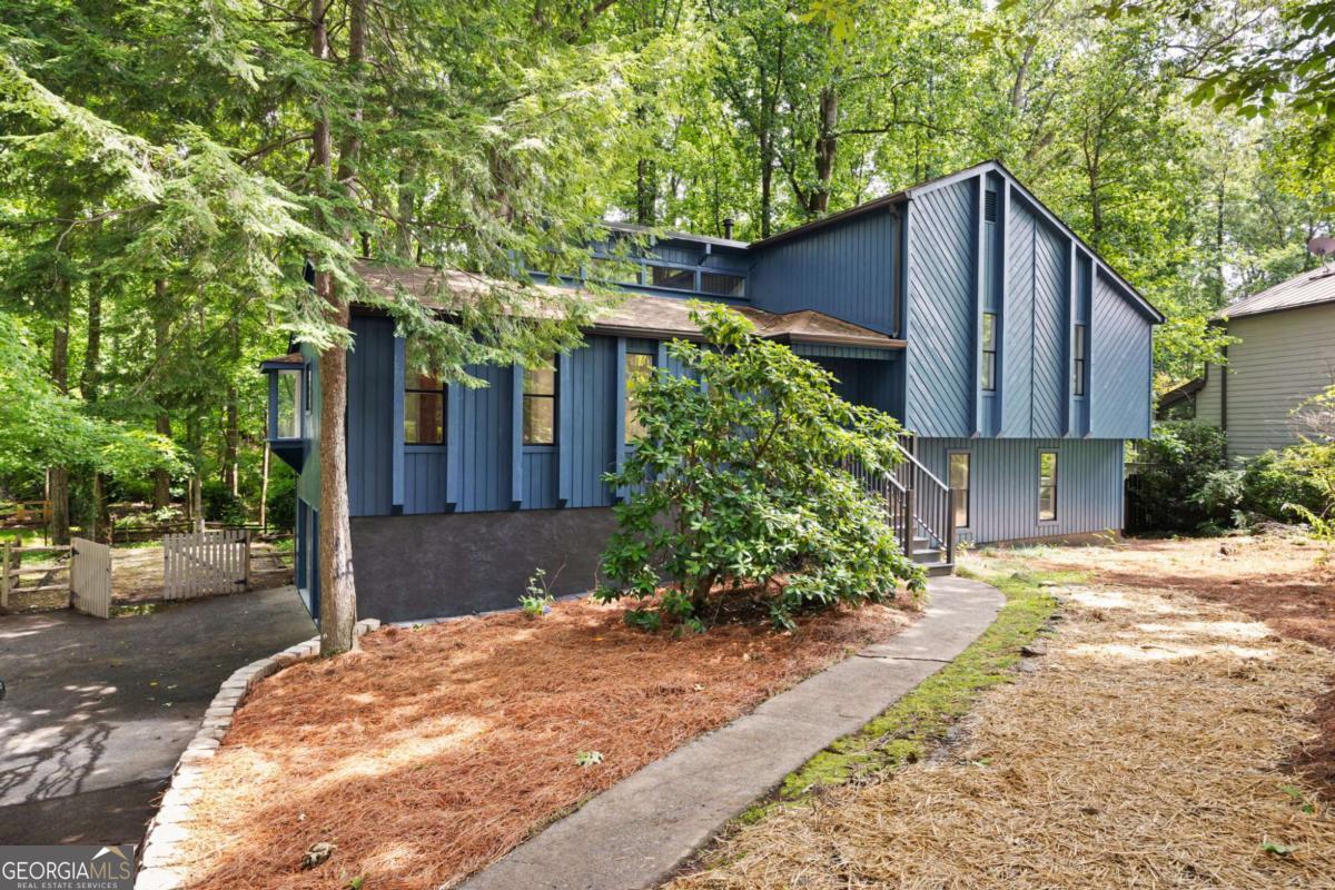 JUST LISTED IN EAST COBB! POPE HIGH SCHOOL! Welcome to this beautifully renovated contemporary home located in the heart of East Cobb, just minutes from top-rated schools, shopping, dining, and more. Nestled in a quiet and desirable neighborhood, culdesac lot, this spacious residence offers modern living with timeless charm. Step inside to discover fresh interior and exterior paint, brand new luxury vinyl plank flooring throughout the main living areas and primary suite, and plush new carpet in the secondary bedrooms. The family room impresses with vaulted wood ceilings, exposed beams, and abundant natural light, while the separate formal living and dining rooms offer versatile entertaining spaces. The fully updated kitchen is a chef's dream, featuring new quartz countertops, tile backsplash, solid wood cabinetry with ample storage, built-in pantry, and a charming custom-built window seat. Downstairs, the lower level boasts a spacious media room, a private bedroom, and a full bath - perfect for guests, in-laws, or a home office setup. Enjoy year-round relaxation in the screened-in sunroom that overlooks a large, private backyard-ideal for gatherings or peaceful evenings. Additional highlights include two laundry rooms, all-new lighting throughout, and updated secondary bathrooms with modern vanities and plumbing fixtures. Located in the coveted POPE HIGH SCHOOL district, this turnkey home offers both style and convenience. Don't miss your chance to own this one-of-a-kind property!