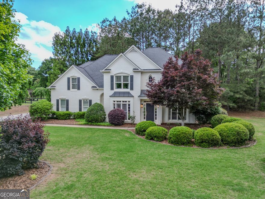 Discover this move-in-ready home at 5 Arabian Ave., nestled within the highly sought-after Oxford Lakes community. This impressive 4-bedroom, 3.5-bath residence offers a harmonious blend of sophisticated design and the comfortable flow essential for modern family life. As you approach, the manicured landscaping and elegant architecture hint at the quality within. Step inside and be welcomed by a dramatic two-story great room, where a soaring ceiling amplifies the natural light and a wood-burning fireplace serves as a cozy focal point, all beautifully framed by an elegant coffered ceiling - perfect for both grand entertaining and relaxed evenings.    For those who require a dedicated workspace or desire a flexible living area, the thoughtfully designed main-floor study provides a tranquil retreat. With the option of closing the stylish French doors, this versatile space easily transforms into a private guest room, offering convenience and flexibility for visiting family and friends. The heart of the home is the bright and airy kitchen, a culinary enthusiast's delight featuring crisp white cabinetry, sleek granite countertops that offer ample workspace, and a gas cooktop. The central island provides a space for meal prep and good conversation, while the inviting eat-in area, bathed in natural light, offers picturesque views of the private backyard - a perfect setting for morning coffee or casual dining. The seamless flow between the kitchen and the great room ensures effortless interaction and makes entertaining a breeze.    Ascend the staircase to discover four generously sized bedrooms / flex spaces, each offering comfort and privacy. The truly luxurious owner's suite is a private oasis, boasting ample space for a sitting area and a spa-inspired ensuite bath. Indulge in relaxation with a soaking tub, a separate tiled shower, and dual vanities, creating your own personal retreat. Two additional well-appointed full baths on the second level provide convenience and comfort for the entire household.    Outside, the expansive, level lot unfolds like a private park, surrounded by mature, lush landscaping that ensures tranquility and privacy. Imagine endless possibilities for outdoor enjoyment - from lively summer barbecues on the patio to children playing freely on the manicured lawn, or even cultivating a vibrant garden. The sheer size of the backyard and side yard also presents exciting potential for future enhancements, perhaps a custom pool or even a home addition. Practicality meets convenience with the three-car side-entry garage, offering ample parking and storage space. Furthermore, recent updates including fresh exterior paint and newer, well-maintained systems (HVAC, water heater, and a reliable 9-year-old roof) provide years of worry-free living and significant peace of mind.    Nestled in a premier North Fulton school district, this exceptional home also offers unparalleled convenience, with just a short drive to the vibrant attractions, restaurants, boutiques, and parks of Crabapple, Alpharetta, and Roswell. This is more than just a house; it's a lifestyle opportunity. Priced below recent appraisal for immediate and substantial equity - don't miss this incredible chance to own your move-in-ready dream home in Oxford Lakes! Call us today to schedule your private showing and experience the magic of 5 Arabian Ave. firsthand.