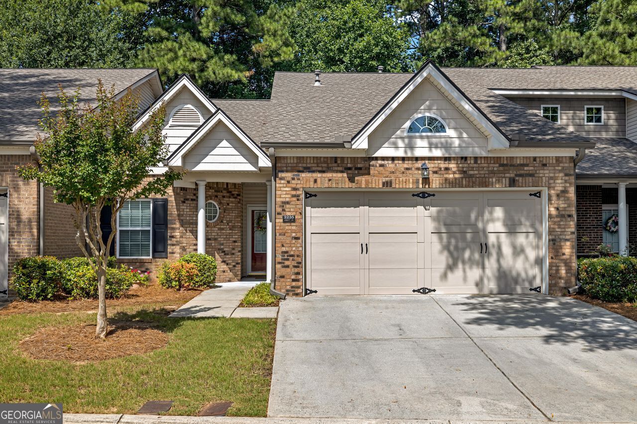 Tucked away at the end of a quiet street in a close-knit community, this beautifully maintained, move-in ready home is ideally situated at the cul-de-sac, offering added privacy and minimal through traffic. Enter through the storm door into the welcoming foyer, where turning left leads you to a spacious secondary bedroom featuring stunning vaulted ceilings-perfect for guests, a home office, or creative space. Just outside the bedroom, you'll find a full bathroom complete with a shower/tub combination, ideal for visitors or family members. Continuing down the hallway, the home opens up into a bright and airy open-concept living area. The family room offers a warm and inviting atmosphere with gleaming hardwood floors, a gas fireplace framed in elegant granite, and built-in bookshelves for both style and storage. To your right, enjoy a seamless view into the modern kitchen, showcasing granite countertops, stainless steel appliances, recessed lighting, and an eat-in dining area highlighted by a vaulted ceiling. Just off the kitchen and near the garage entrance is a conveniently located laundry room. Circling back through the family room, head to the right and step into the expansive owner's suite. This tranquil retreat features a beautiful trey ceiling, a large walk-in closet, and a spa-like ensuite bathroom. You'll love the double vanities, a newly tiled, oversized step-in shower with minimal threshold, vaulted ceilings, tiled flooring, a linen closet, and a private water closet. From the owner's suite, step through charming double glass French doors into a spacious sunroom filled with natural light-perfect as an office, hobby room, or even an additional guest room. A storm door leads you out to a private outdoor patio area, ideal for morning coffee or relaxing evenings. As you exit the home, you'll appreciate its desirable location near the end of a quiet cul-de-sac, offering added privacy. Before exiting the community, enjoy a short stroll to the nearby clubhouse, which features a fitness center and sparkling pool-perfect for relaxing or socializing. The HOA fee includes water, termite control, dwelling exterior, and lawn maintenance, giving you peace of mind and more time to enjoy your home, ensuring low-maintenance living. Conveniently located near I-75, I-20, the East-West Connector, the Silver Comet Trail, and the airport, this home offers quick access to major commuter routes, outdoor recreation, and everyday essentials.
