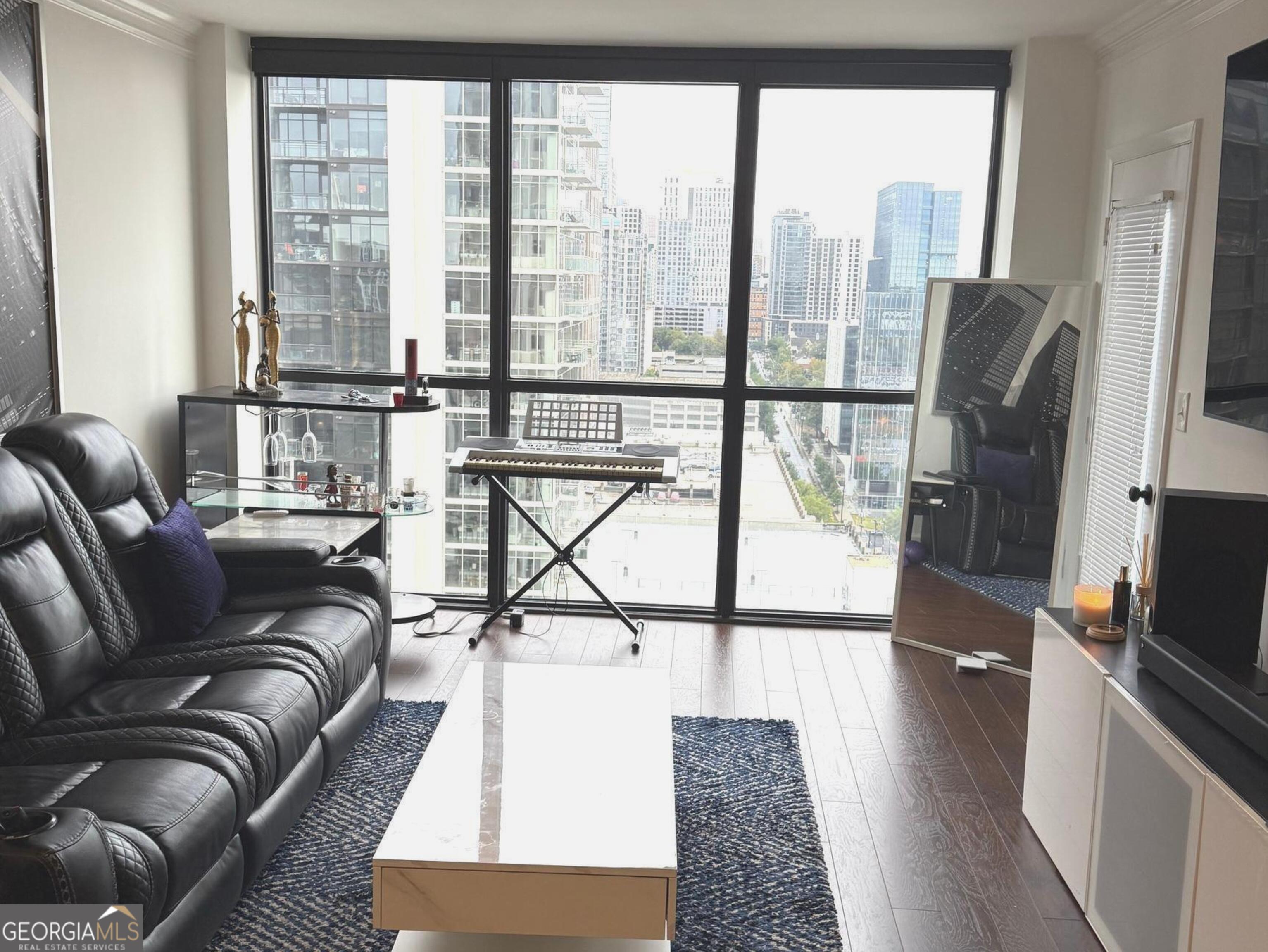 Awesome 28th Floor 2 bedroom 2bath condo overlooking the heart of Midtown Atlanta! This condo boasts beautiful scenic views from every room in this space from its ceiling to floor windows. It all starts with an inviting entry into an intimate foyer that leads to the main attraction which starts with a kitchen thats equipped with granite counter tops, stained cabinetry, ceramic flooring, and a pass-thru window, making it easy to connect with family and guest. Not to mention, still be able to take in the beautiful views in the living room! The living room is adorned with hardwoods floors, large picturesque view of the city and an entrance out onto the balcony for further exposure. Topped with all of this, comes a master bedroom with an oversized walk in closet for all your fashion essentials. Oh, let's not forget.. your very own private balcony entrance! Lastly, a secondary bedroom on the opposite side offering up hardwood floors, private full bath and another room with a view. In addition, the common areas includes a swimming pool, tennis courts, meeting areas, billiard room, fitness center, concierge and more.. A Must See gem in the heart of Midtown, its Lifestyle and Convenience at its Best!