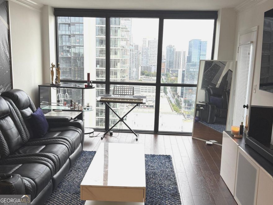 Awesome 28th Floor 2 bedroom 2bath condo overlooking the heart of Midtown Atlanta! This condo boasts beautiful scenic views from every room in this space from its ceiling to floor windows. It all starts with an inviting entry into an intimate foyer that leads to the main attraction which starts with a kitchen thats equipped with granite counter tops, stained cabinetry, ceramic flooring, and a pass-thru window, making it easy to connect with family and guest. Not to mention, still be able to take in the beautiful views in the living room! The living room is adorned with hardwoods floors, large picturesque view of the city and an entrance out onto the balcony for further exposure. Topped with all of this, comes a master bedroom with an oversized walk in closet for all your fashion essentials. Oh, let's not forget.. your very own private balcony entrance! Lastly, a secondary bedroom on the opposite side offering up hardwood floors, private full bath and another room with a view. In addition, the common areas includes a swimming pool, tennis courts, meeting areas, billiard room, fitness center, concierge and more.. A Must See gem in the heart of Midtown, its Lifestyle and Convenience at its Best!