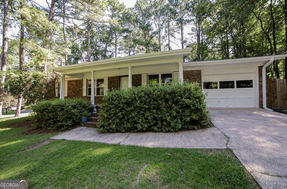 West Athens Charmer. - Presenting a move-in ready ranch, offering the perfect blend of condition and a convenient in-town locale. DETAILS: *3 Bedrooms/2 Full Baths *1215 SqFt. *Year Built - 1980 *.40 Acre Corner Lot. SPECIAL FEATURES: -NEW Luxury Vinyl Plank Floors (2 Bedrosm) & NEW Carpet in Living Areas, -NEW Interior Paint -Updated Double Paned Windows -Newer Water Heater (2023) & HVAC (2020) -Masonry Wood-burning Fireplace. FLOOR PLAN: -Flowing Formal Layout. -Inviting front Living Room with corner, brick fireplace and coat closet receives you upon entry. -The living area extends to the spacious Dining Room, or this space can be utilized as a Keeping Room if you prefer. Bright and full of light, the Dining Room features sliding glass doors to the exterior. -Just around the corner is the eat-in kitchen offering room for a small breakfast table, boasts a newer stainless stove/oven, white cabinets, and is complete with upgraded vinyl floor. -The Laundry Room can be found tucked inside the garage, accessed through the Kitchen. -Grouped together down the hall are the cozy bedrooms and full baths. -The Primary Bedroom has been upgraded with new LVP floors and provides its own ensuite full bath with tiled shower. -One of the accessory bedrooms also offers new LVP floors, and both secondary bedrooms are complete with ample closet space and quick access to the hall bathroom. EXTERIOR: ~Private Rear Deck, ~Privacy-fenced Rear Yard, ~Herb Garden, ~Covered, Rocking-chair Front Porch, ~Concrete Walkways and Driveway. EXTRAS: -Electric AC, -Gas Heat, -Gas Water Heater -City Water and sewer -Brick Front. LOCATION: -City Bus Stop 1 block away. -Within .7 miles to Jefferson Rd/Hwy. 129. -Quick access to Loop 10. -5 miles to Downtown Athens and UGA. Easy in-town living, this well-maintained home is ready to welcome you!