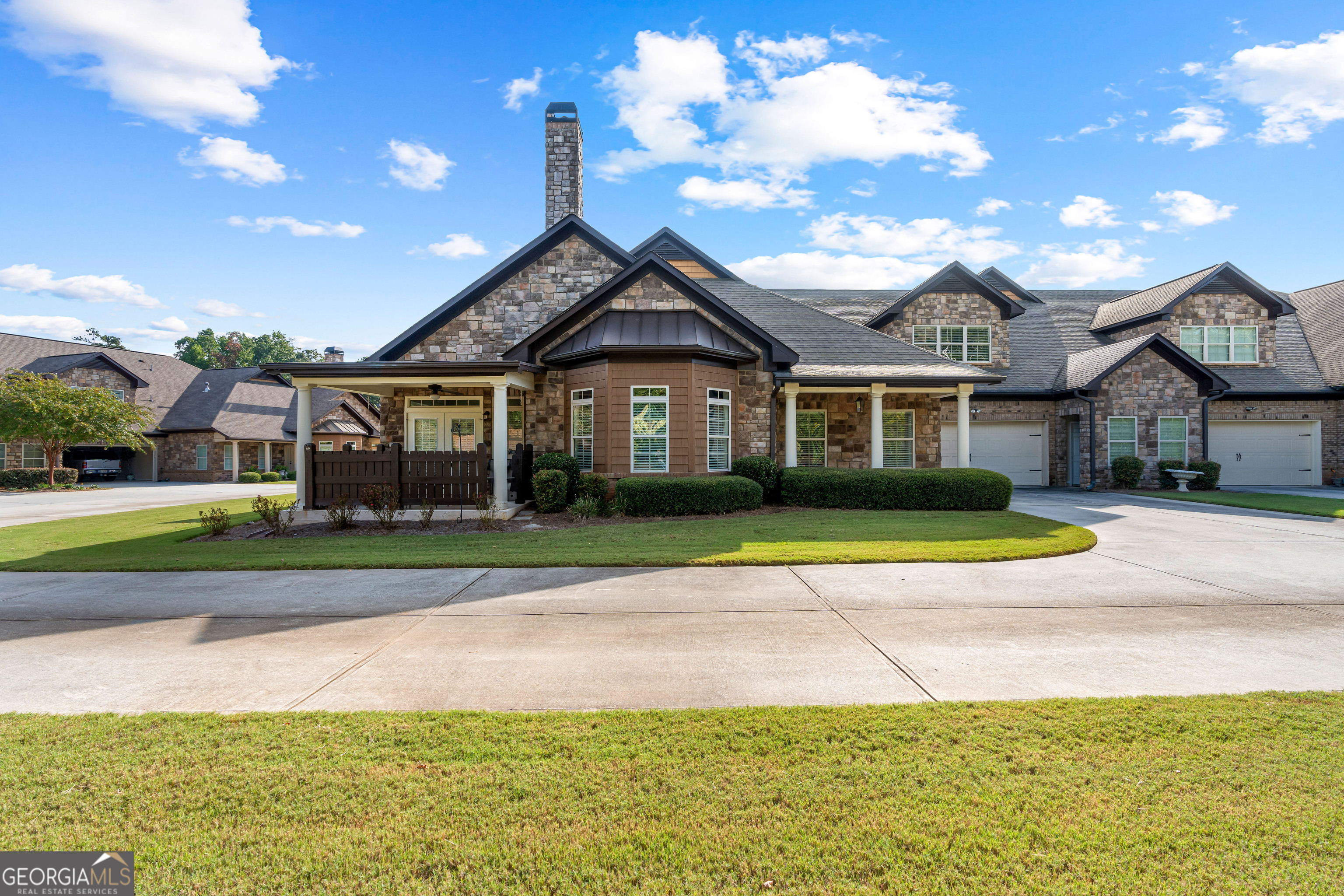 Don't miss this charming, move-in ready townhome in Acworth's 55+ active adult community, just moments away from historic downtown Acworth and Lake Allatoona. This specious four-bedroom home offers the perfect blend of luxury and low-maintenance living. With a thoughtfully designed floor plan and high-end finishes, this residence is ideal for comfortable and stylish living. Step inside and discover an elegant main level with 10' ceilings, 8' doors, hand-scraped engineered hardwood floors and 10" base molding. The open-concept layout creates a seamless flow between the living room, dining area and kitchen. The living room, complete with cozy fireplace is the perfect spot to relax. A separate sitting room/office area provides a quiet space for work or leisure. The kitchen contains beautiful granite countertops, a tiled backsplash and under-counter lighting. The oversized pantry provides plenty of storage space. The spacious laundry room, located off the kitchen offers additional room for shelving or a stand-up freezer. The main floor hosts a large primary suite and two additional bedrooms. The primary bedroom features a double tray ceiling and French doors that lead to the bathroom. This bathroom has two separate granite topped vanities and a large tiled walk-in shower. One of the secondary bedrooms is an en-suite, with a tiled shower in the bathroom. Upstairs, you'll find a complete private suite, including a generous living area, full bathroom and bedroom. This versatile space is ideal for extended family, a dedicated hobby area or a private guest retreat. Enjoy your coffee on the inviting front porch. The home also includes a spacious two-car garage. The HOA covers all the essentials including water, trash, lawn care and exterior maintenance, giving you more time to enjoy everything this fantastic community/location have to offer. This is your chance to experience a turn-key lifestyle in a prime location!