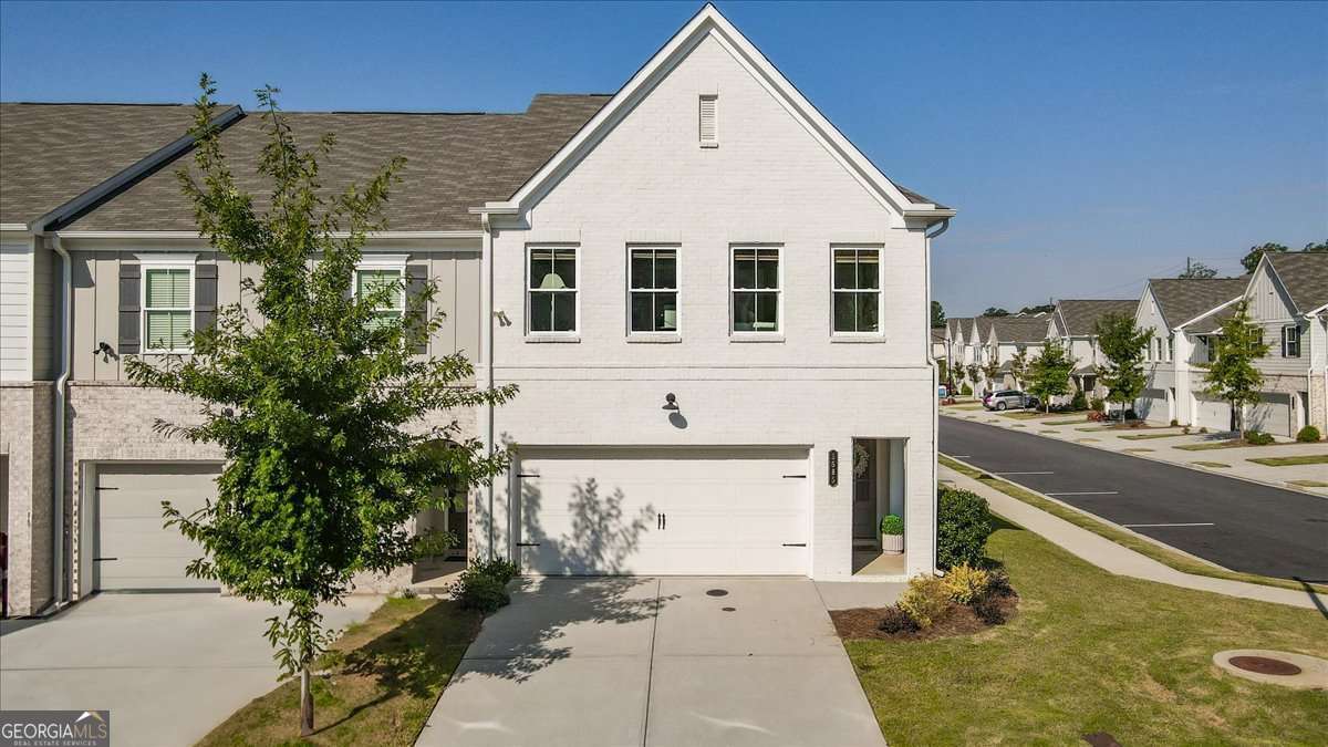 Don't miss this *end-unit* townhome in Tapp Farm! This 3 bedroom, 2 bathroom unit gets amazing natural light and features a main-level 2-car garage, tastefully updated interiors, and a versatile loft space perfect for an office. It does not back up to the main road, giving you extra peace and privacy. Enjoy the top-of-the-line community amenities including a pool and pickleball courts, plus direct access to the Silver Comet Trail right outside your neighborhood. This home is truly move-in ready and has been impeccably maintained for its next owner!