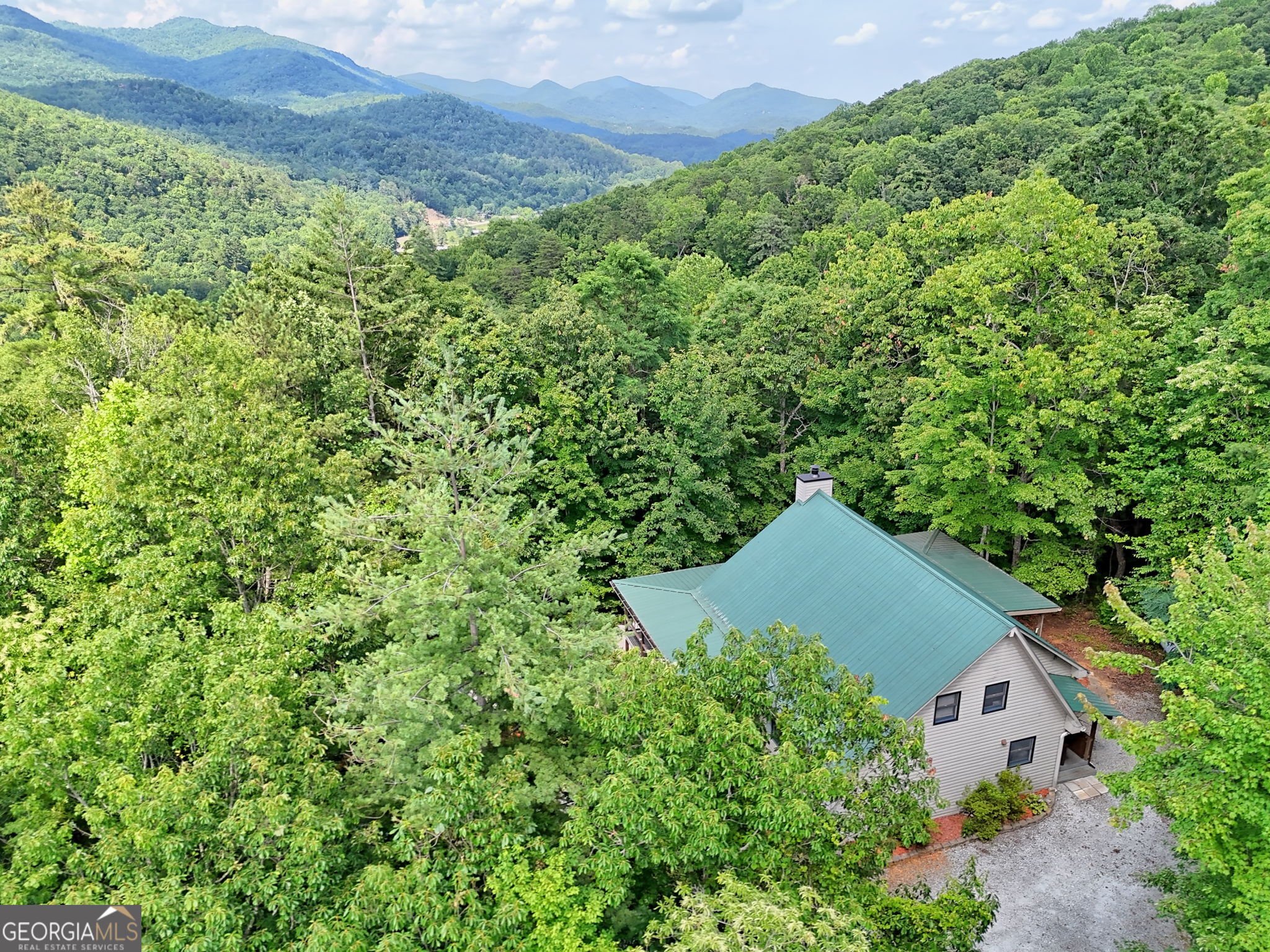 Tucked away on nearly 2 wooded acres just minutes from Lake Burton and the vibrant town of Clayton, this inviting 2-bedroom, 2-bath mountain cabin offers the perfect blend of rustic charm and modern comfort. Inside, you'll find a spacious 1,624 sq ft open floor plan with soaring tongue-and-groove wood ceilings and a cozy wood-burning fireplace that brings warmth and character to the great room. The main level features a generously sized master bedroom with a walk-in closet and an upgraded bathroom boasting a tile shower and double vanity. Upstairs, a second bedroom and upgraded full bath with a tile shower. This great space provides privacy and comfort for family or guests. The kitchen includes abundant counter space, a walk-in pantry, and a convenient laundry room just off the side. A dedicated dining area flows seamlessly into the great room-ideal for casual gatherings and everyday living. A partial unfinished basement includes a one-car garage with both interior and exterior access, offering great potential for storage or a workshop area. Surrounded by peaceful woods and offering seasonal mountain views, this home is your private mountain retreat. Come fall in love with Clayton, Georgia-a hidden gem in the North Georgia Mountains with a lively downtown, charming shops and restaurants, and endless outdoor adventures. And don't forget Lake Burton-a 2,775-acre lake known for its scenic beauty, bass and trout fishing, and year-round recreation!