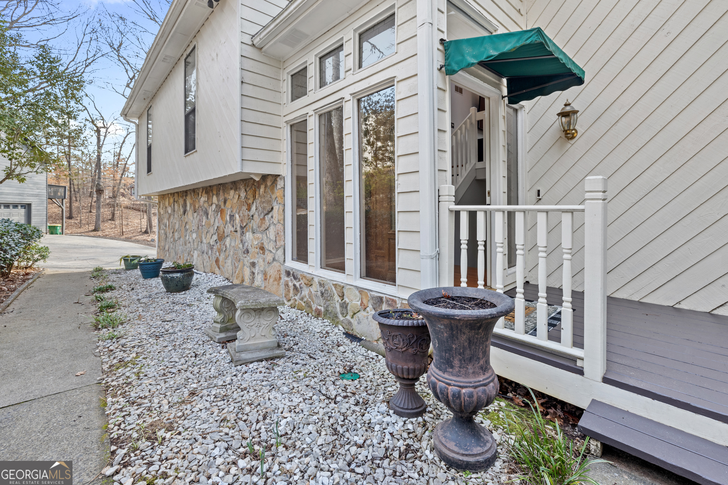Tucked away in the peaceful Rivermont neighborhood, this beautiful 3-bedroom home sits on a private wooded cul-de-sac lot with the perfect location and zoned for highly sought after schools. Inside, you'll find real hardwood floors, soaring ceilings, and skylights bringing in tons of natural light throughout. The expansive two-level deck stretches across the back of the house, providing a perfect spot to relax and enjoy views of the serene, low maintenance backyard. The kitchen has been thoughtfully updated with sleek granite countertops, modern cabinetry, and stainless steel appliances. Each of the three bedrooms features spacious walk-in closets, with the master suite offering a vaulted ceiling, a updated en-suite bathroom, and direct access to the back deck. The fully finished basement offers additional living space, with a large recreation room, wet bar, half bath, and walk-out access to the covered back deck, making it ideal for gatherings and entertaining. Rivermont is an exclusive North Fulton community, known for its premier amenities, including the nearby Rivermont Park, a private 27-acre riverside retreat with walking trails, playgrounds, and a community stage for concerts during the warmer months. Residents also have the opportunity to join the Rivermont Golf Club, a hidden gem that offers an exceptional golfing experience, with discounted social memberships available for homeowners. Conveniently located near GA-400, Roswell, and Alpharetta, this home offers the perfect combination of seclusion and accessibility, making it an ideal retreat from the everyday hustle and bustle.