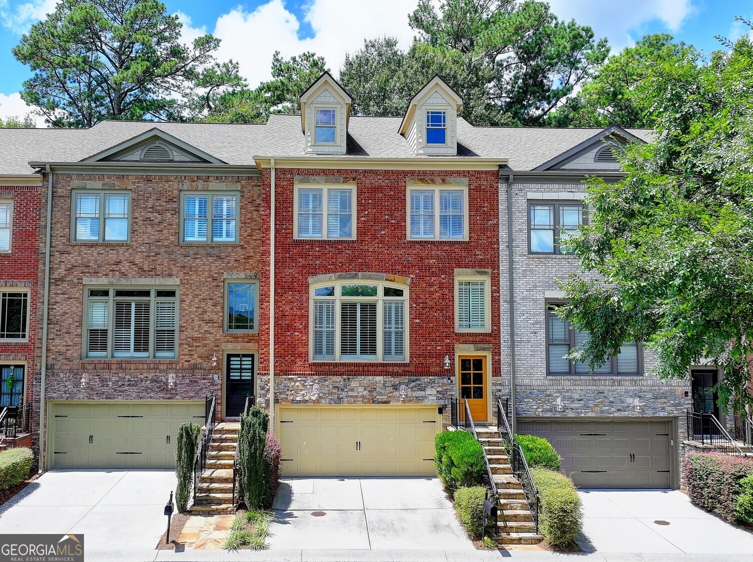 Stunning 4 BR/3.5 BA in gated intimate community conveniently located in Sandy Springs near North Buckhead. Walk to Trader Joes and Chastain Park! This spacious townhome features oak hardwoods throughout and an elevator connecting all floors. All rooms are bathed in natural light and windows have plantation shutters. Enter the cozy 2-story foyer and step into the family room complete with gas fireplace and built-in bookshelves. Separated by columns, the formal dining room with coffered ceiling and wainscoting has a butlers pantry connecting to the chef's kitchen boasting professional grade SS appliances and new vent hood. Adjacent breakfast room opens to the private deck with a stone fireplace with new insert and gas logs, for year-round enjoyment. Ascend upstairs to a central loft space centered between the elevator, two bedrooms (and a shared hall bathroom), the laundry room (with washer and dryer), and the primary suite with tray ceiling, large walk-in closet with shelving system, large tiled shower, jetted tub, and dual sinks. Fully finished terrace level has a large room that can be an additional BR, office or gym, and a full bath. In addition, there is access to 2-car garage with storage space and the private wooded backyard patio. Additional guest parking is nearby. Fantastic location near shopping, restaurants, parks, and medical facilities. Don't miss what could be your new home!