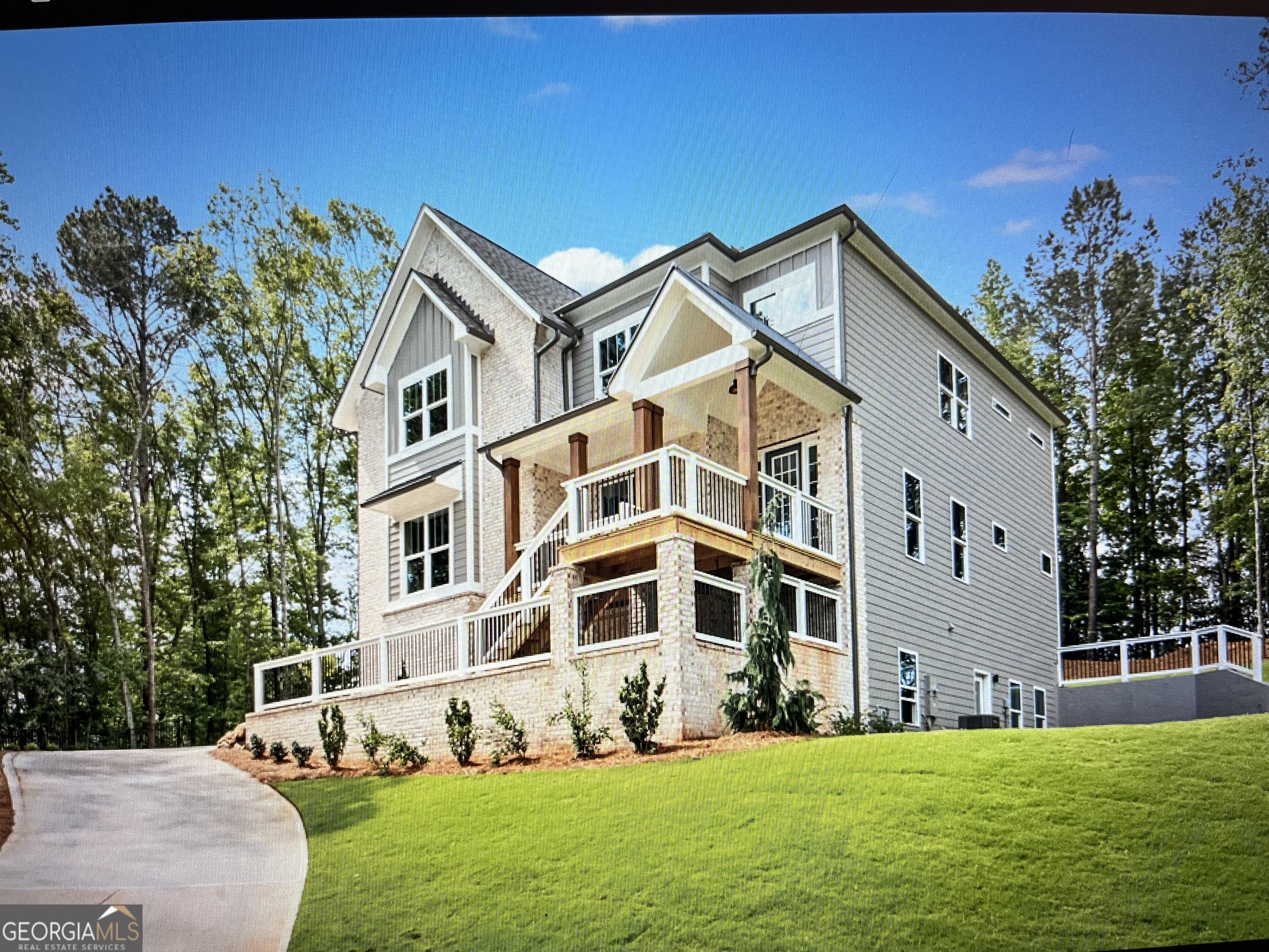 Lot 9 Wesleyan - LAST 2 FINAL OPPORTUNITIES - MOVE IN READY Custom home with basement, covered deck and 3 car garage nestled on a fairytale 1.4 acre homesite nestled in the woods with large backyard and side entry basement - You'll love living in Liberty Springs, a Woodstock community of only 10 homes on large homesites. You'll enjoy the easy flow of Windsong Properties' popular Wesleyan floor plan on a full unfinished side daylight basement. This home offers wide-open living spaces to enjoy with your family and friends. Along with the soaring 10-foot ceilings on main level and 9-foot on second level, this home is decked out with high-end options you won't find anywhere else - quartz countertops, Shrock Entra White cabinets with constrasting island, CAFE' appliances, custom tile in all baths, showers and laundry room and a freestanding soaking tub in the owner's bath along with a large tiled shower with frameless shower door. Located in the cul-de-sac on a 1.4 acre lot backing to trees, you'll love the privacy and the large backyard and covered patio. This home offers a large owner's suite upstairs, a Guest bedroom/office and a full bathroom on the main level. The main level bath is finished with a tiled standing shower and frameless shower door for a total of five bedrooms and four baths. Enjoy the open feel as you enter the main level with soaring ceiling heights and cozy up with modern gas log fireplace in Great Room. The second floor has 4 spacious bedrooms, 3 baths (Owners spa bath, a Jack & Jill and an ensuite bath) and a large tiled laundry room with laundry sink. Each bedroom is spacious with generous-sized closets. Home is under construction and will be ready in 30 days. Photos are of the actual home staged.