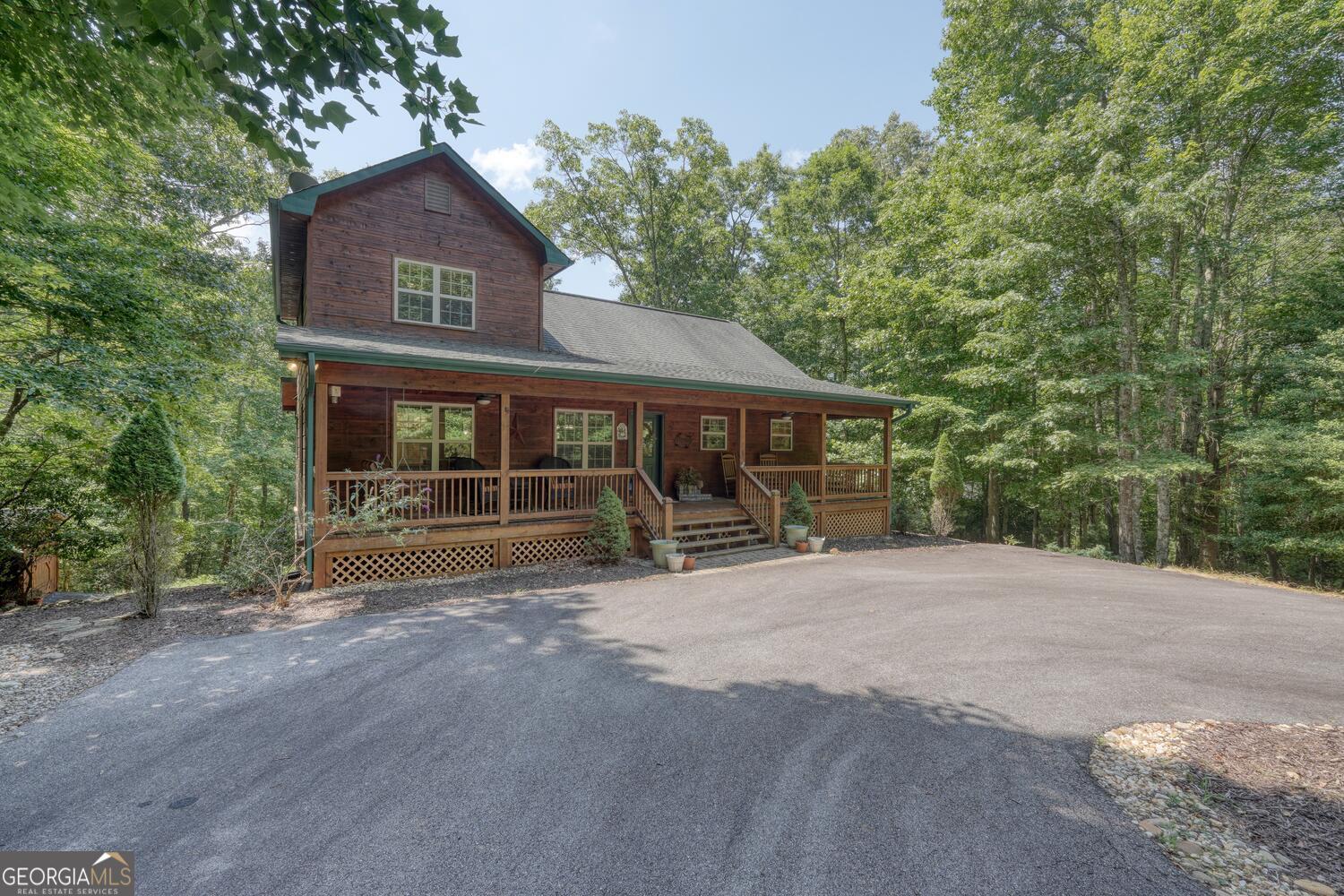 Welcome to 134 Caleb Dr, Blairsville, GA 30512 - a stunning 4-bedroom, 4-bath cabin nestled on 1.807 acres of scenic mountain beauty. This gorgeous home offers breathtaking long-range views and is fully furnished, ready for your mountain retreat or vacation rental. Features include two fully equipped kitchens, perfect for entertaining or large family gatherings, and spacious covered front and back porches to enjoy the fresh mountain air. The inviting fire pit area provides a cozy spot for relaxing evenings with friends and family. Whether you're seeking a peaceful retreat or a lucrative investment property, this beautiful cabin combines comfort, style, and natural beauty in one exceptional package. Don't miss the opportunity to own this mountain paradise!