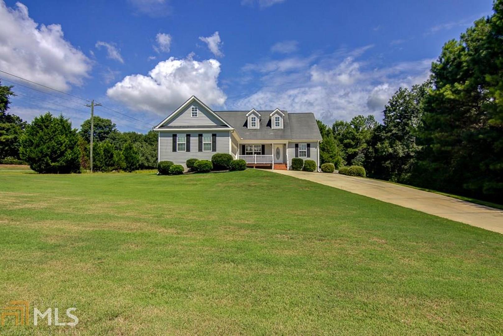 Hard to find renovated ranch on 1.6 acres with finished basement! New paint, carpet, LVP flooring and basement HVAC with 10 yr warranty! Main level features include three bedrooms, two baths, separate dining, open living area w/ fireplace, beautiful quartz countertops in the kitchen plus stainless appliances . Finished basement offers endless possibilities - teen/in-law suite, mancave or kid zone - with full bath, wet bar, three large rooms, walk-in closet and storage. Outside relax on the rocking chair front-porch, rear deck or side patio and enjoy a large 1.6 acre lot which is partially fenced. Conveniently located to downtown Newnan, shopping, restaurants and I-85 for easy commute.