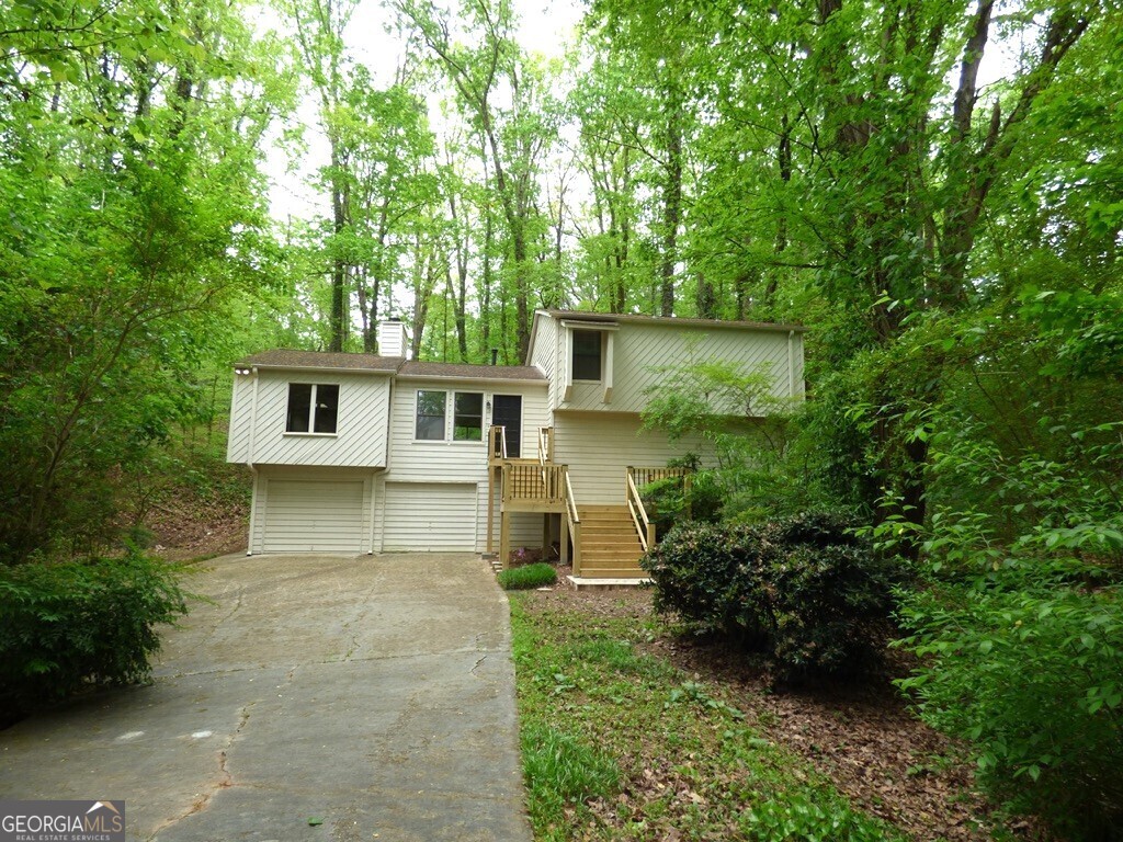 $2500 Seller Paid Closing costs!!!Location Location Location!!Check out this East Cobb home in Shallowford Heights Community and sought after Lassiter School District. Split level floorplan main level consists of an oversized family room with wood burning gas fireplace, updated kitchen with tons of cabinets, and large separate dining room You have sliding glass doors off the family room to walk out onto the back deck overlooking your private backyard. Upstairs you will find the master bedroom/ master bath and 2 generous sized secondary bedrooms and another full bath. Downstairs you will find a 4th bedroom or bonus room or in-law suite and a half bath. Laundry room is also downstairs and access to 2 car garage. Long driveway leads to tons of parking. Home has many upgrades new paint inside and outside, newer roof, updated flooring, updated kitchen cabinets, brand new front steps and new lighting. This home is move in ready. Do not miss out on seeing this one.