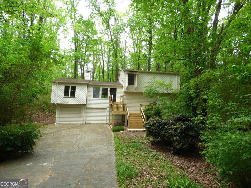 $2500 Seller Paid Closing costs!!!Location Location Location!!Check out this East Cobb home in Shallowford Heights Community and sought after Lassiter School District. Split level floorplan main level consists of an oversized family room with wood burning gas fireplace, updated kitchen with tons of cabinets, and large separate dining room You have sliding glass doors off the family room to walk out onto the back deck overlooking your private backyard.  Upstairs you will find the master bedroom/ master bath and 2 generous sized secondary bedrooms and another full bath.  Downstairs you will find a 4th bedroom or bonus room or in-law suite and a half bath.  Laundry room is also downstairs and access to 2 car garage.  Long driveway leads to tons of parking.  Home has many upgrades new paint inside and outside, newer roof, updated flooring, updated kitchen cabinets, brand new front steps and new lighting.  This home is move in ready.   Do not miss out on seeing this one.