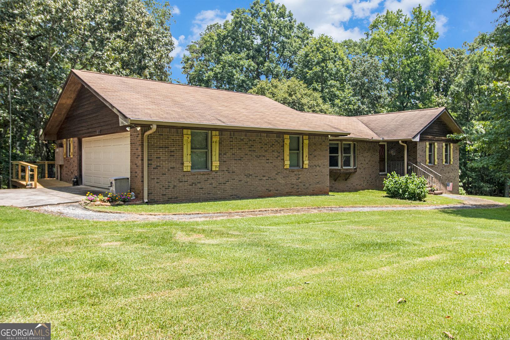 Check out this amazing 3-bedroom ranch set on 15 ACRES and just a few minutes from Young Americans Christian School!!! IN-LAW APARTMENT in basement!!! PLUS there is a SECOND three-bedroom house that can be used to generate rental income. No HOA. Don't wait! Call now to schedule a tour. This property won't last long! A full basement with a beautifully designed living space. This is a dream for nature lovers, featuring a barn/workshop, and serenity! The home offers solid raised panel doors, a spacious living room with gorgeous built-ins and a dining area that flows seamlessly into a wonderful sunroom that brings in so much natural light. Kitchen is outfitted with stainless steel appliances and a walk-in pantry that is sure to delight the house chef. The finished basement features a bedroom and full bathroom with kitchenette; ideal for an in-law setup or could be an income-producing space. Right from the basement, step outside onto a covered patio and then continue to the accessory dwelling that has 3 bedrooms and 1 bathroom and a central heat pump, just waiting to be customized with your vision. While outside, check out the barn that has five roll up doors plus an awesome workshop for the DIY enthusiast. Brand new oversized deck is sure to be the hit spot for family time and entertaining. The acreage is ideal for relaxing and taking in the surroundings, picking blueberries from one of many bushes, swinging, or hammocking in an expansive, private setting. Approximately three miles from the sought-after. Fantastic buy for owner-occupant that has a creative concept for developing the property further and living off the land. This is also a great opportunity for an investor/developer. Come with your dreams and tour today!