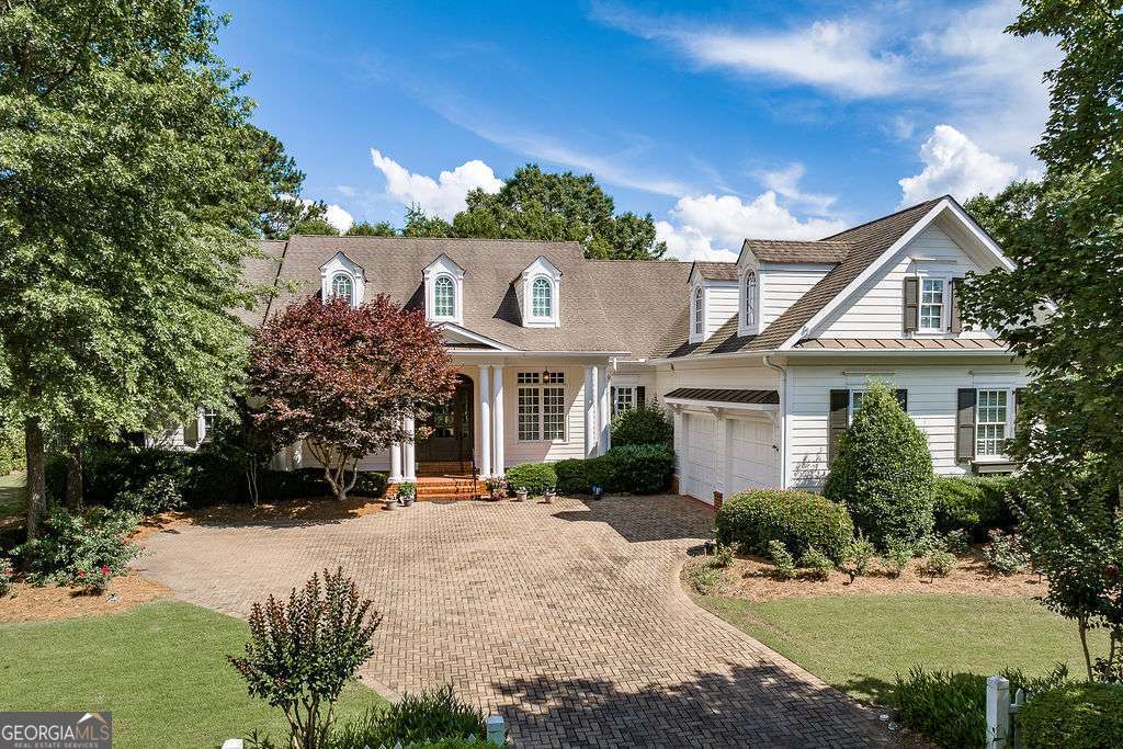 Beautiful ranch-style home in The Georgia Club offering one-level living with a newly finished basement and stunning golf course views! Located on a 0.41-acre lot in the Horseshoe Bend section, this 4-bedroom, 4.5-bathroom home boasts timeless charm, high ceilings, gorgeous hardwood floors, and detailed crown molding throughout. Built in 2006, the main level features a split-bedroom layout with three bedrooms, each with a private bathroom, plus a private office, half bath, and bar area. Open-concept living spaces flow seamlessly from the kitchen to the keeping room and den each featuring a cozy fireplace along with a breakfast area and vaulted grand room. Step out onto the expansive screened porch that spans the back of the home ideal for relaxing or entertaining while overlooking the golf course and beautifully landscaped backyard.The brand-new finished basement adds a fourth bedroom, full bath, and a unique turf room perfect for indoor golf practice or workouts. Additional rooms in the basement provide flexible space for a movie room, storage, or whatever suits your needs. Just outside the walk-out doors, youll find a covered patio with even more space to enjoy the peaceful golf views. Situated in Barrow County, this home is part of The Georgia Clubs gated, golf cart-friendly community offering access to resort-style amenities including golf, swimming, tennis, fitness, and on-site dining. Experience where luxury meets comfort and every day feels like a getaway.