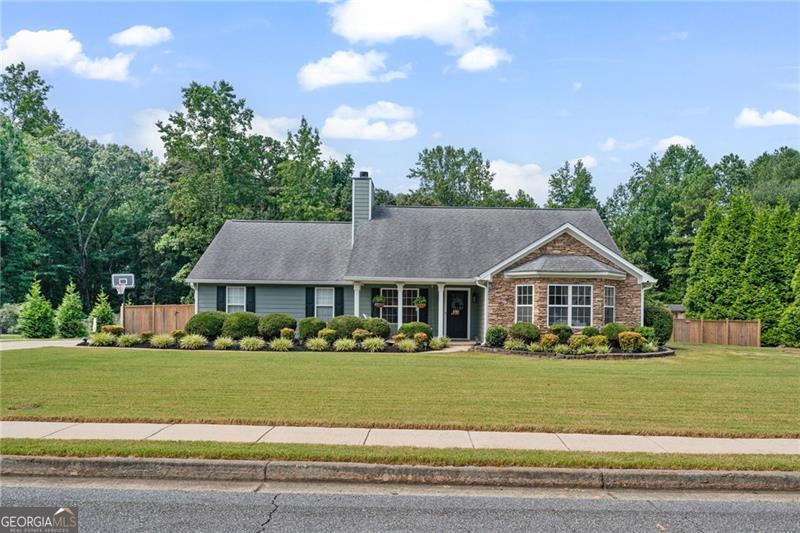 Welcome to your dream home in Buford, GA! Situated on a spacious and private lot, this beautifully updated 3 bed / 2 bath ranch offers the perfect blend of modern convenience and homie charm inside and out. Step inside to an open-concept layout that flows effortlessly from the living area into a fully upgraded kitchen featuring all-new Whirlpool appliances, including a double oven with electric cooktop, refrigerator, and dishwasher. Smart blackout shades (voice-controlled with Alexa) let you instantly set the mood, while upgraded lighting and finishes create an inviting, warm ambiance throughout. The primary suite is pre-wired for your wall-mounted TV, and even the laundry room is thoughtfully equipped with desk space, ideal for remote work or daily organization. Step outside and enjoy your very own private retreat. The freshly painted exterior, new front door, and modern, matching exterior lights set the tone from the curb. Out back, you'll love the 6ft wood privacy fence enclosing a peaceful, oversized yard complete with a composite wood deck that's perfect for entertaining and a greenhouse ready for your green thumb or year-round hobbies. Whether you're relaxing, planting, or hosting friends this backyard was made for it all. Additional upgrades include a Nest doorbell camera, ATD alarm system, and dedicated TV wiring in the back patio, primary suite, and guest bedrooms. This home is more than a place to live, it's where memories are made. Located just minutes from shopping, dining, top-rated schools, and all the charm Buford has to offer, this gem won't last long!